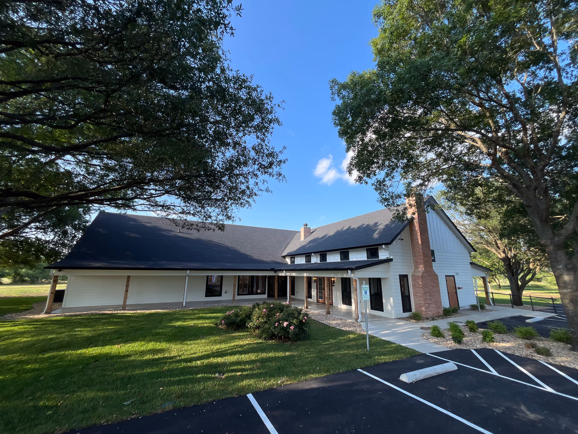 Exterior view of Serenity View Assisted Living and Memory Care building with trees and parking.