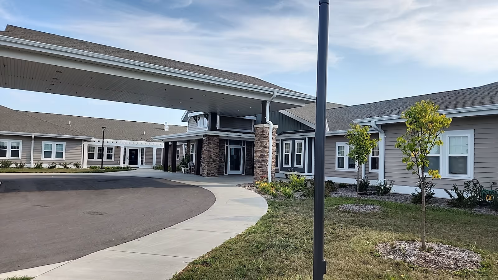 Exterior view of Rolling Hills Nursing Home entrance with curved driveway and landscaping.