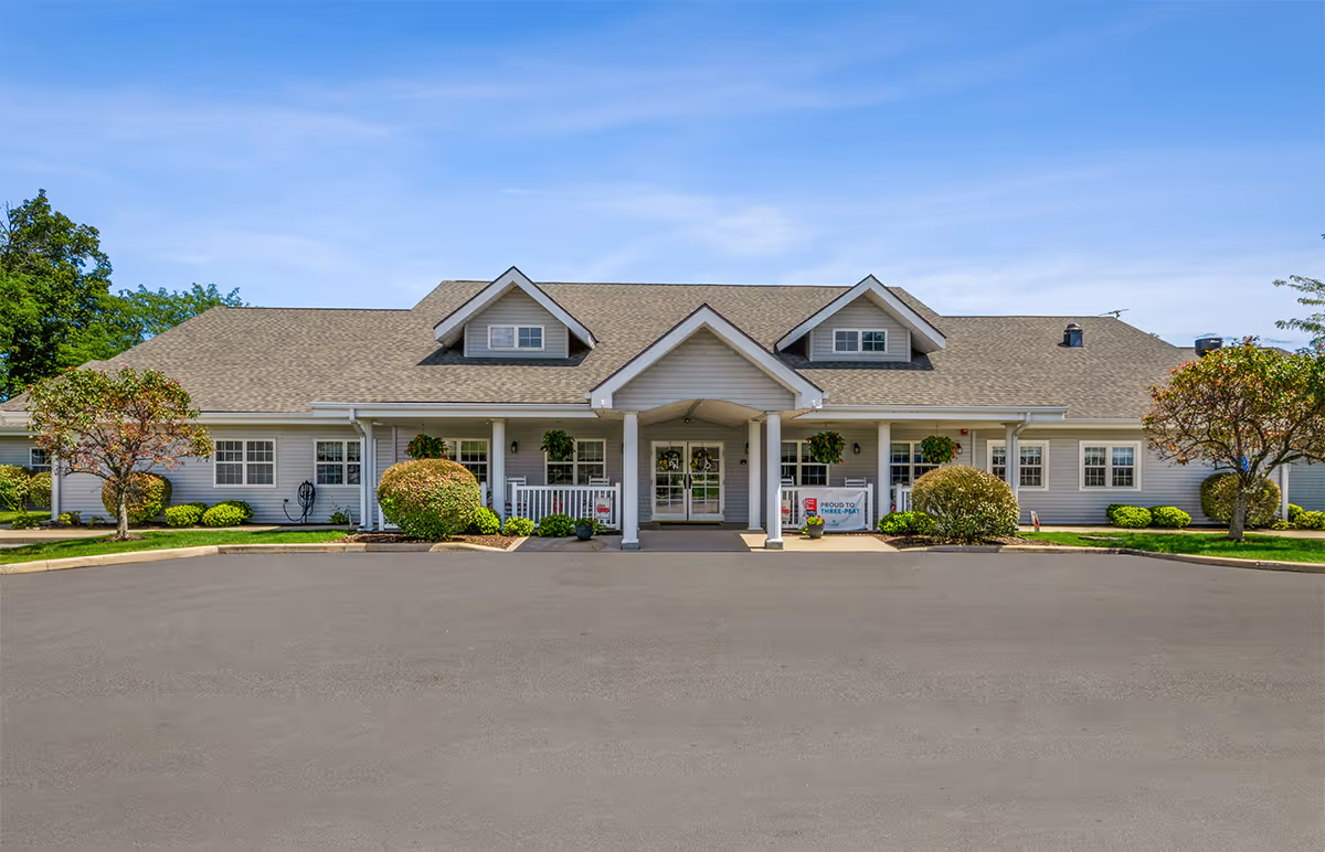 Front view of Walker Place senior living facility with entrance portico and landscaped grounds.