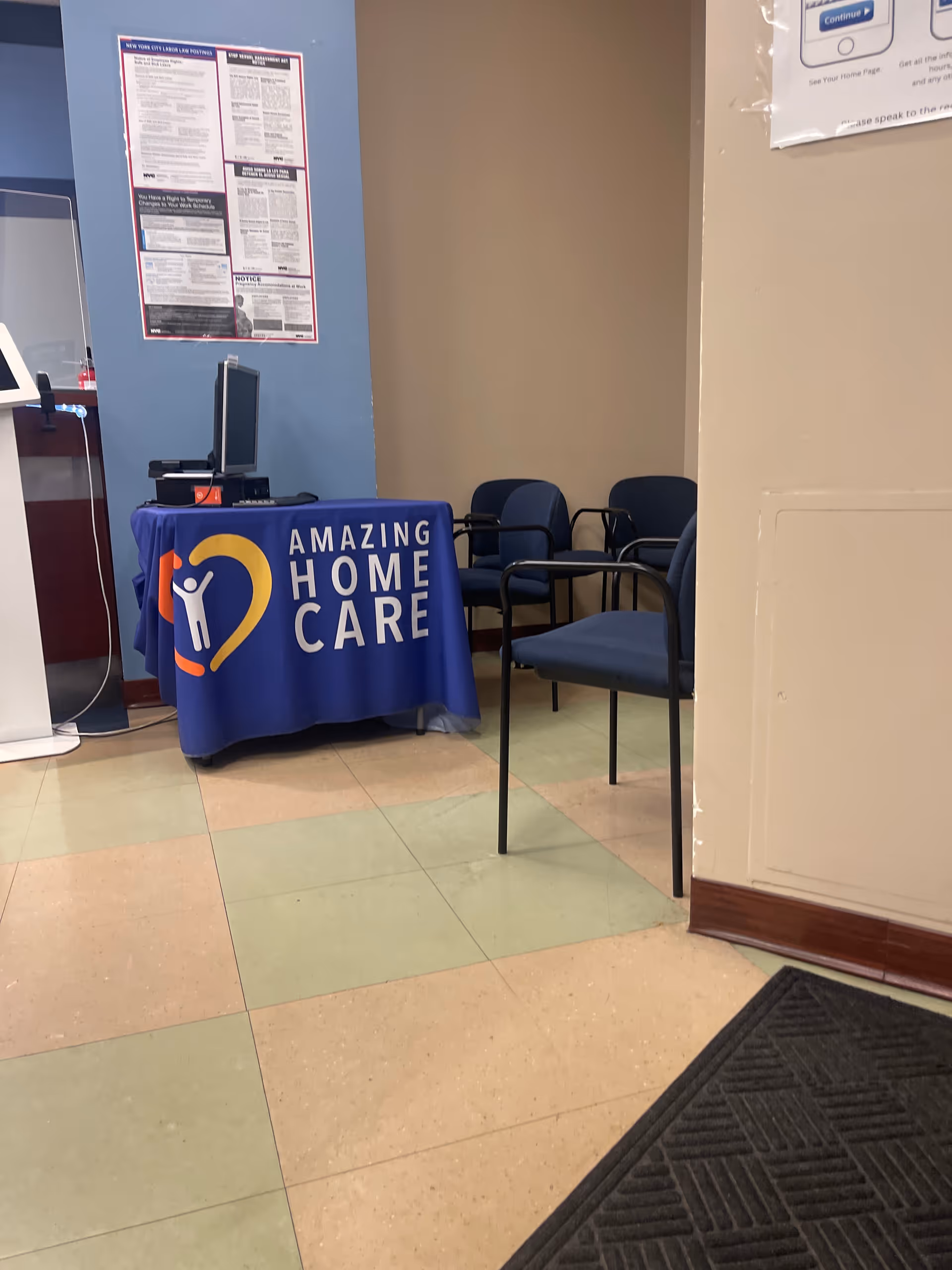 Reception area featuring a blue tablecloth with Amazing Home Care logo and chairs.