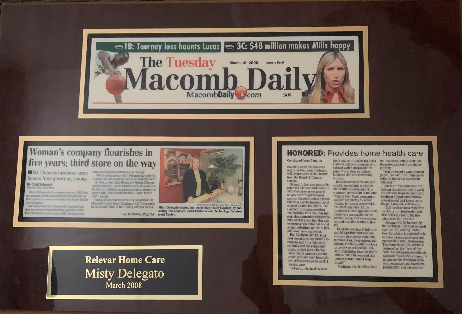 Wall-mounted framed newspaper clippings and a plaque honoring Relevar Home Care.