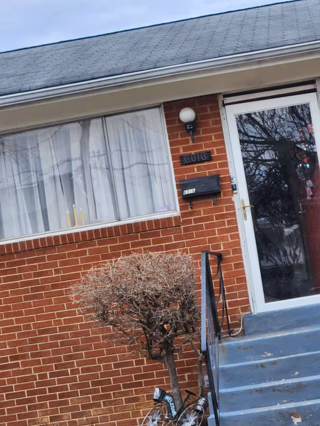 Brick exterior of Renee's Place Assisted Living with front door and steps.