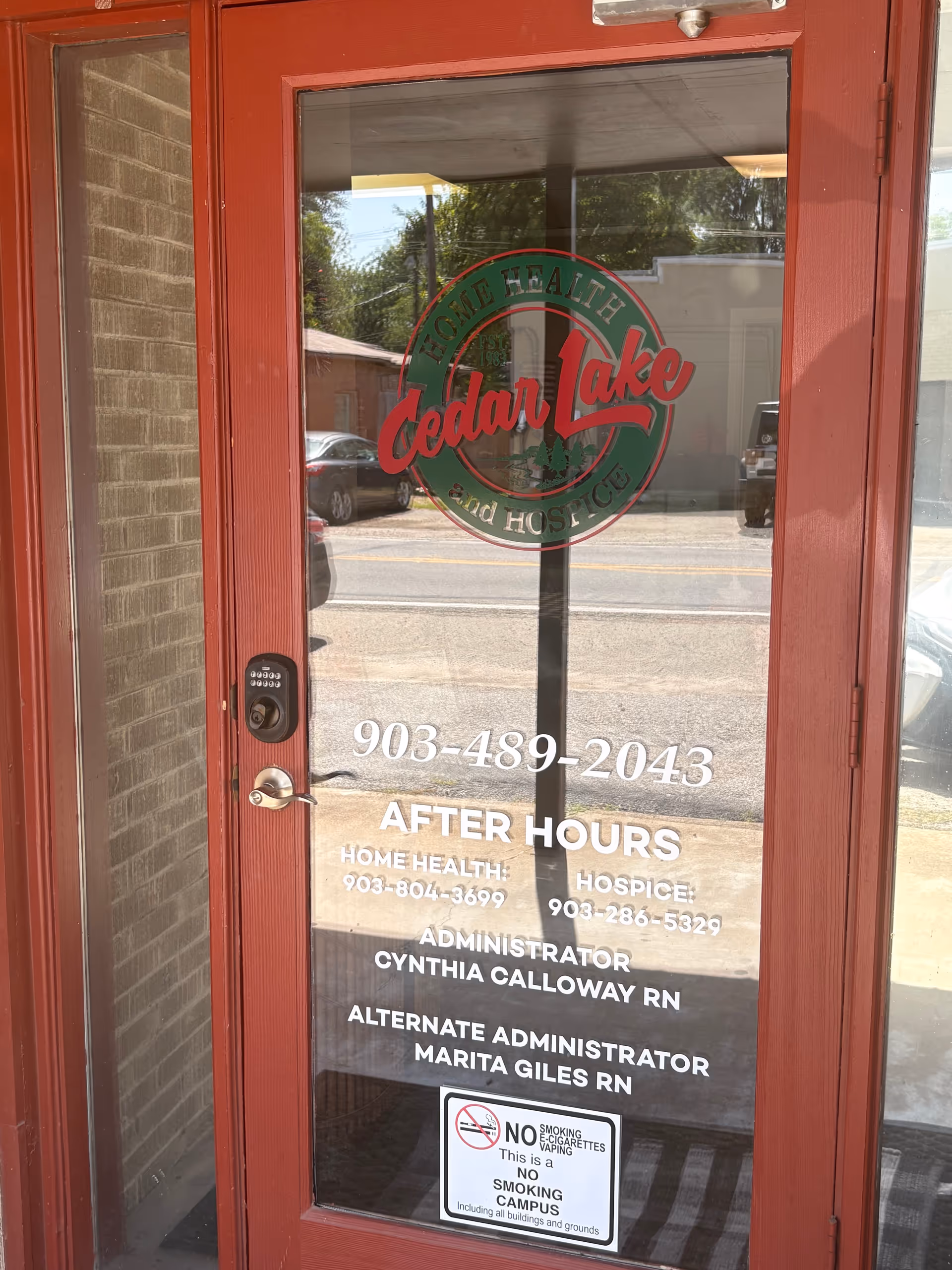 Glass front door featuring Cedar Lake Home Health & Hospice logo and contact details.