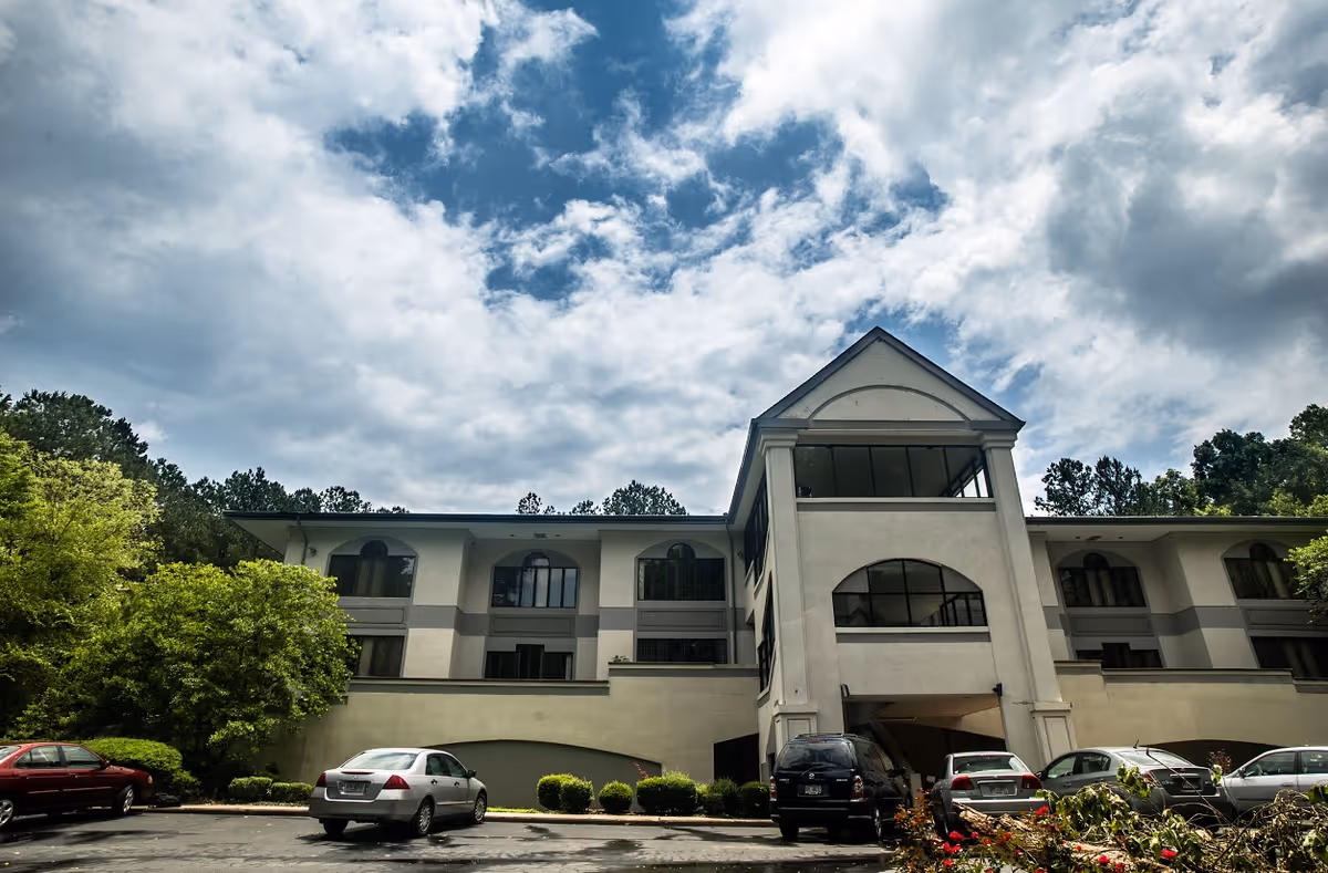 Front view of Medside Healthcare senior living building with parked cars.