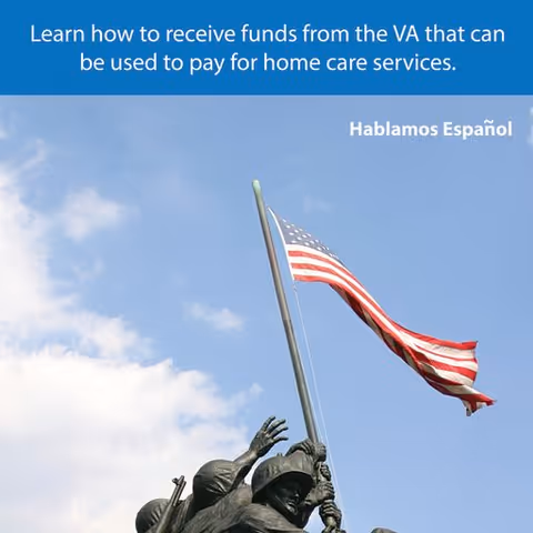 Statue of soldiers raising a flag against a blue sky.