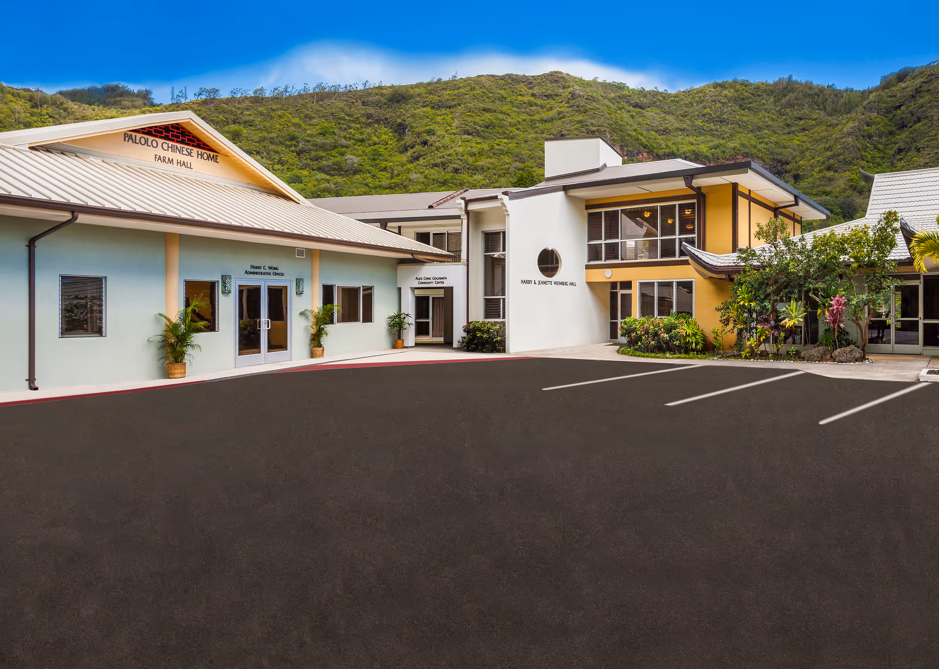 Exterior view of Palolo Chinese Home facility with parking and hillside backdrop.