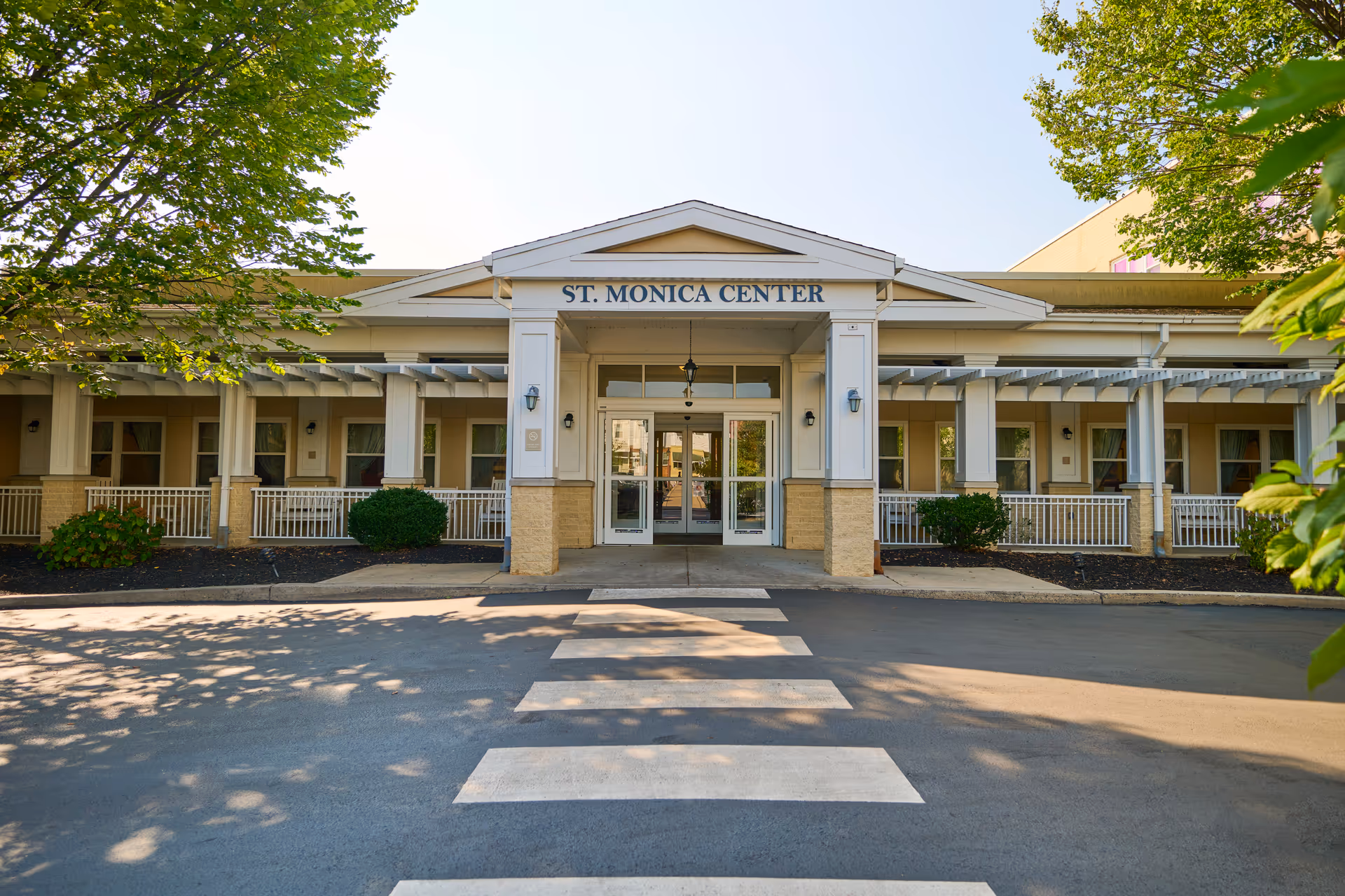 Front exterior of St Monica Center entrance with a pedestrian crossing.