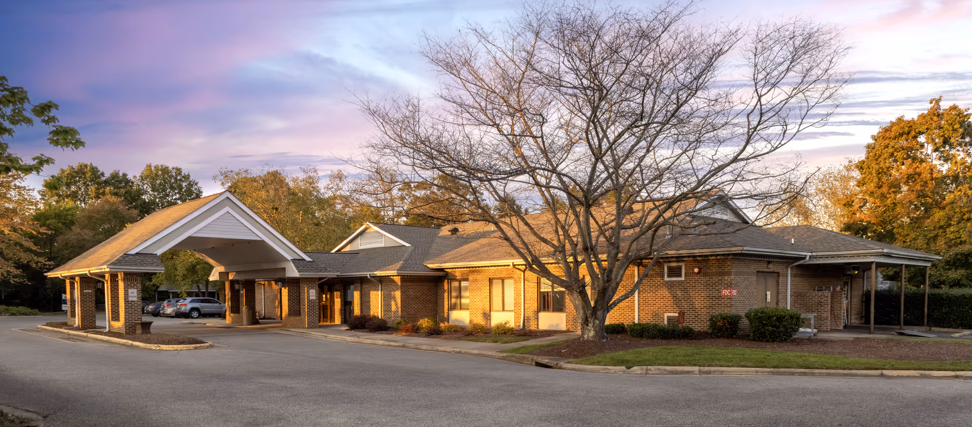Exterior view of Brantwood NH & Retirement Center, brick building with porte-cochère.