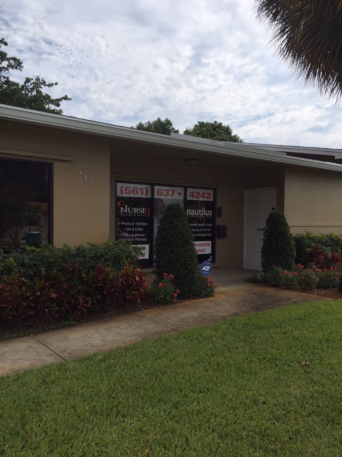 Front exterior of Nurse 1 Home Healthcare with landscaping, signage, and a walkway.