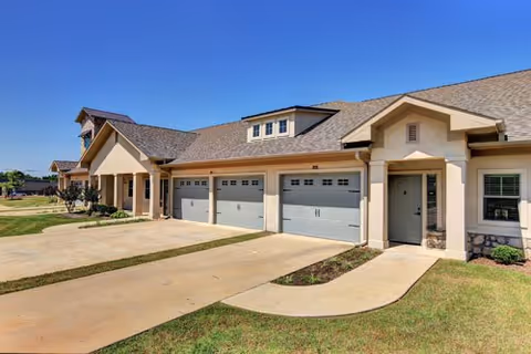 Front view of Arabella of Athens Senior Living with three garage doors and main entrance.