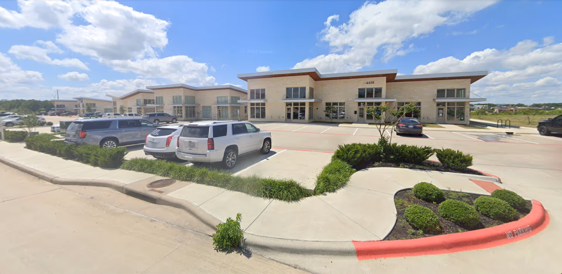 Exterior view of Century Home Care Partners facility with parking, entryway, and landscaped curb