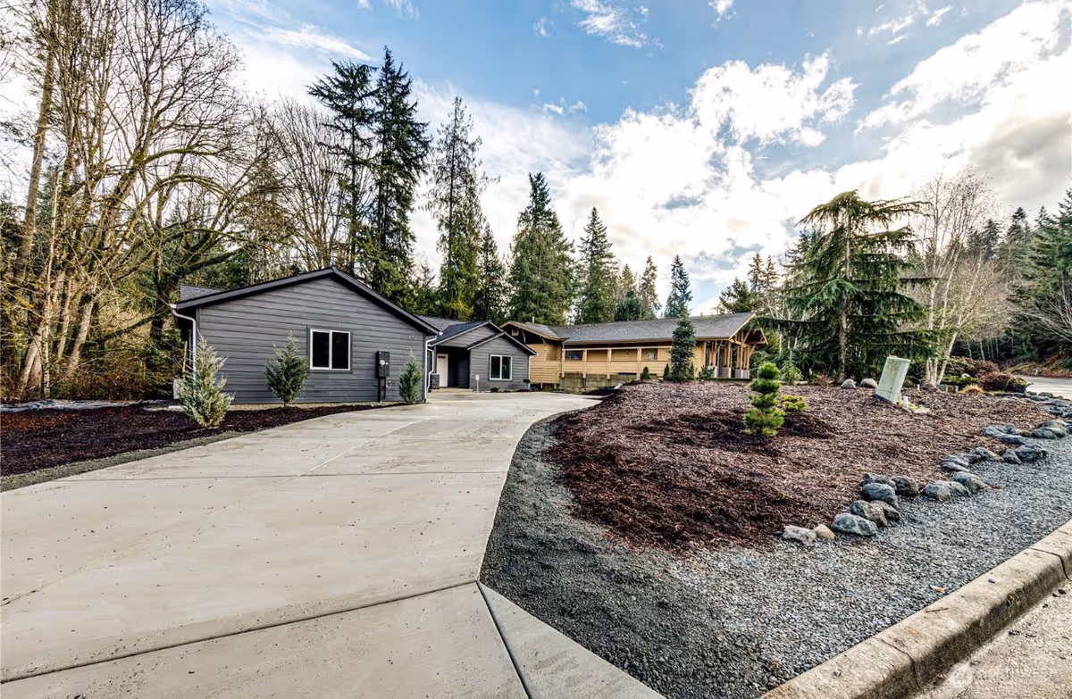 Exterior view of Action Adult Family Home showing a curved driveway and landscaped grounds.