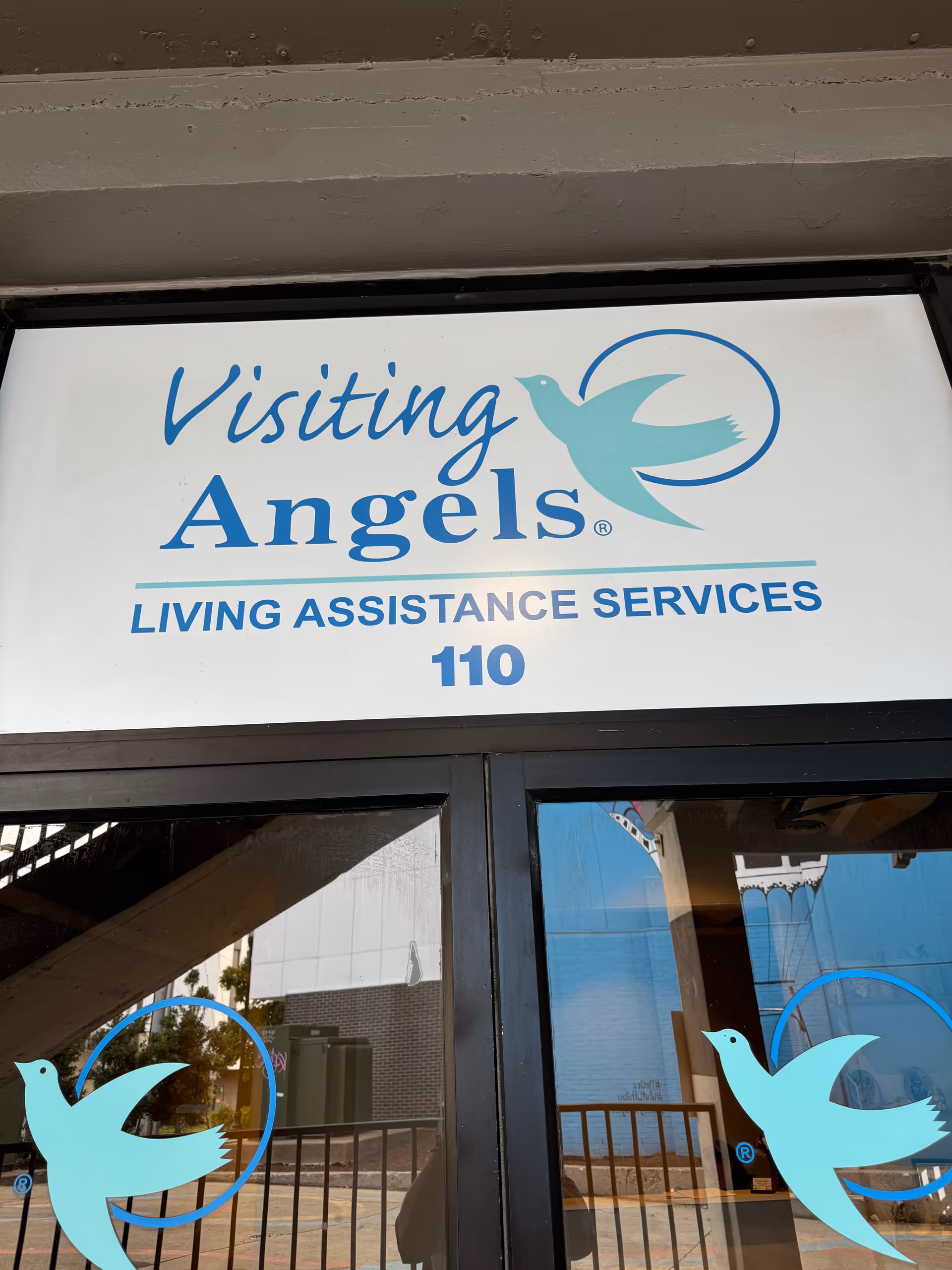 Exterior sign reads Visiting Angels Living Assistance Services Nashville on the building front.
