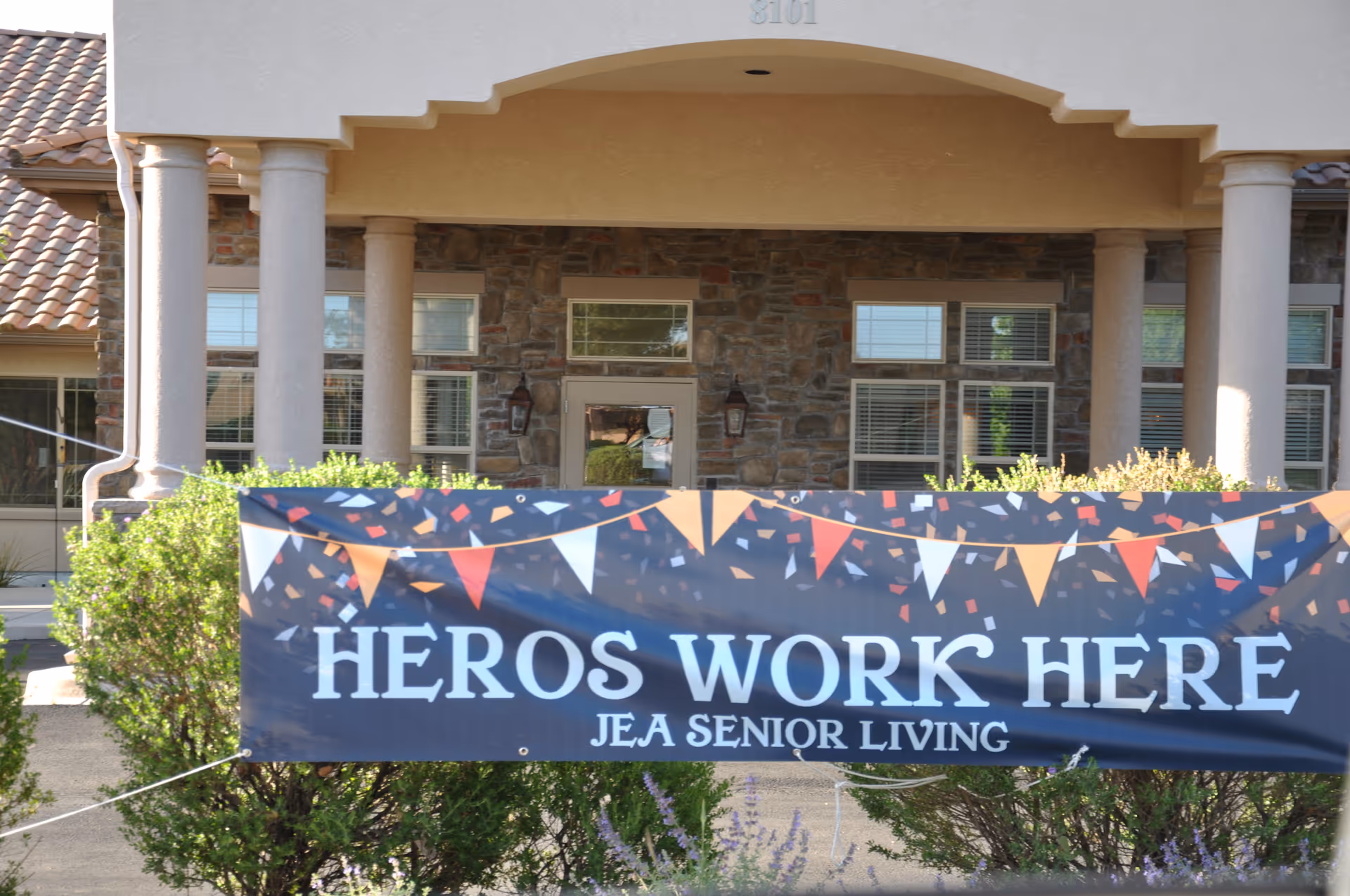 Front view of Morningstar North Ridge senior living building with a decorative banner.