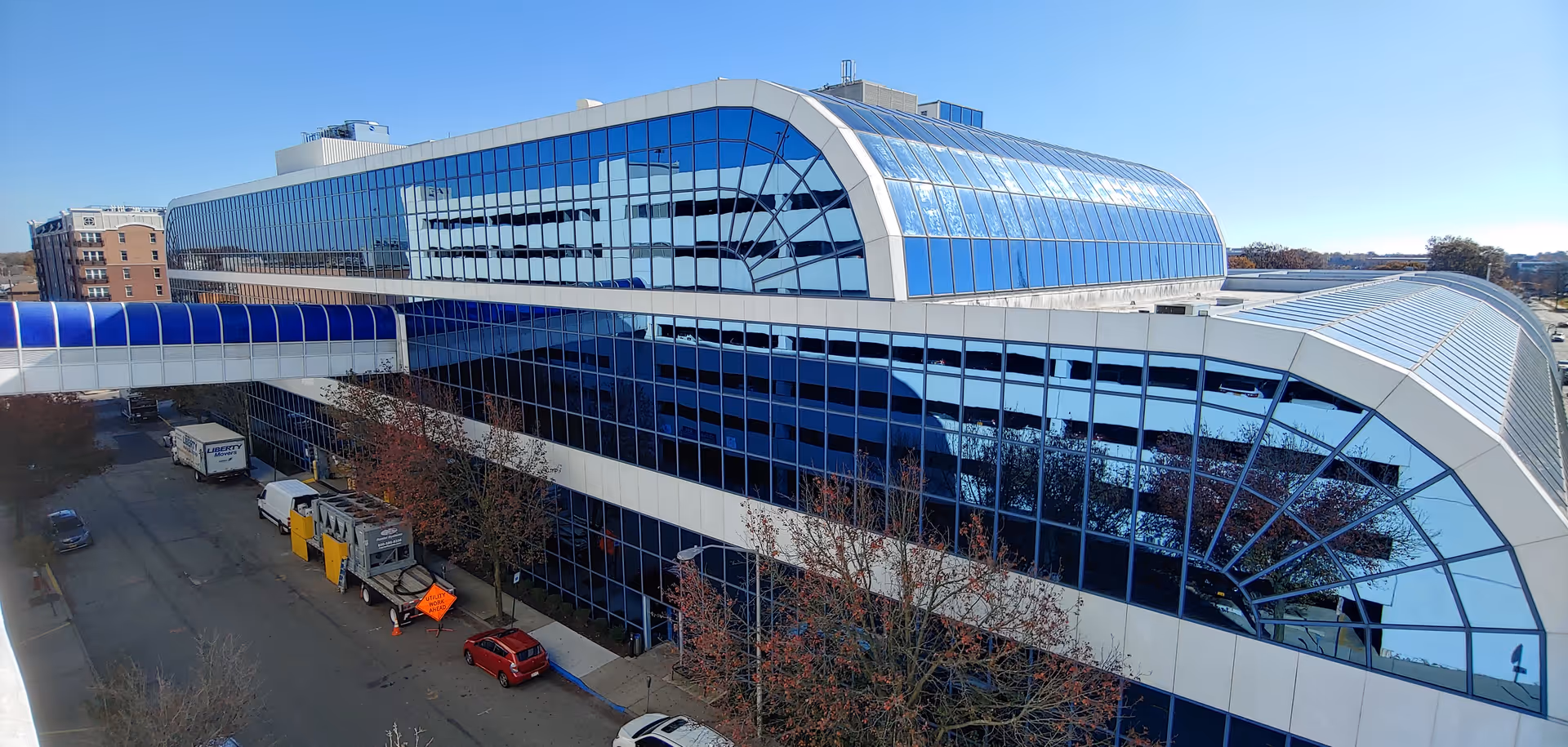 Exterior view of a modern glass-front ambulatory care building with curved roof.