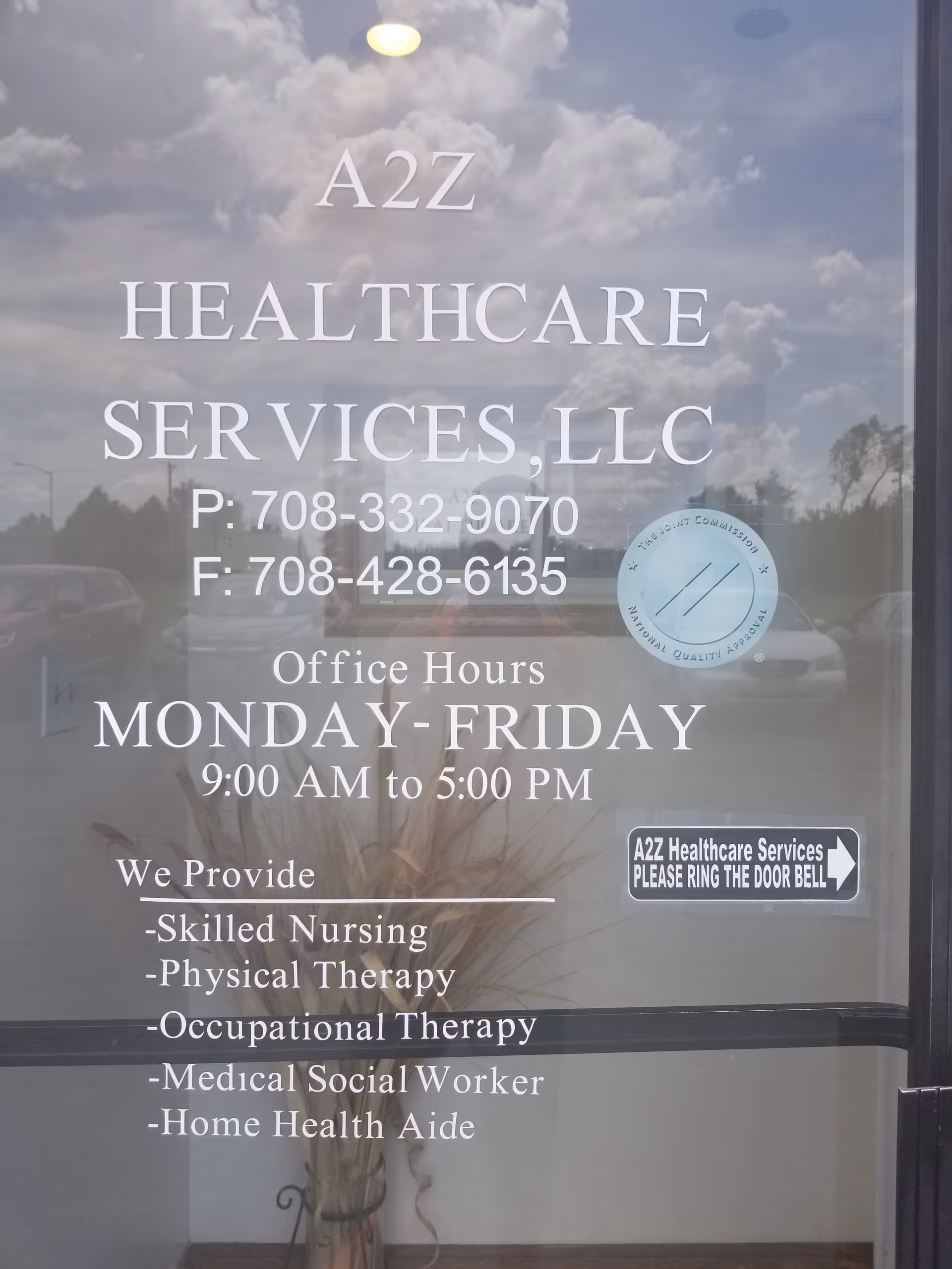 Glass storefront door displays A2Z Healthcare Services contact info and office hours.