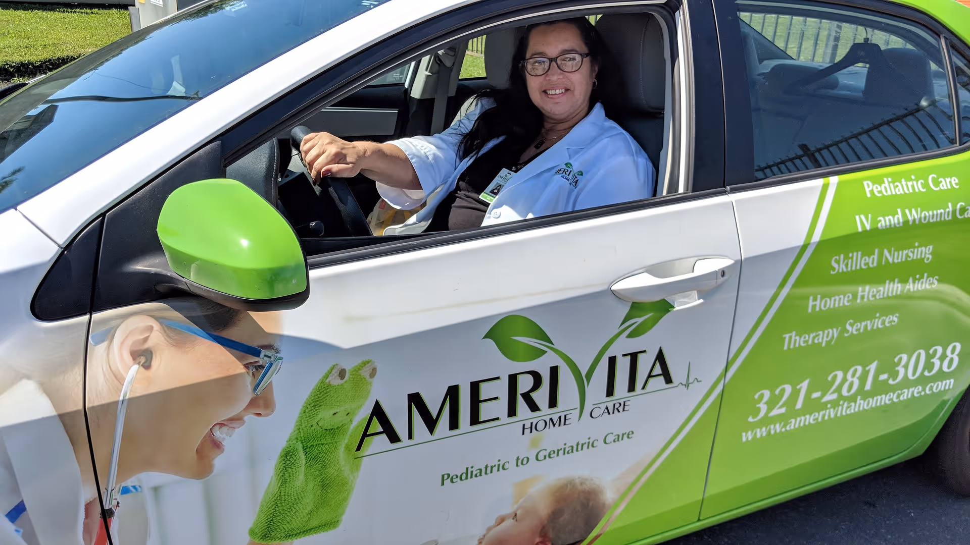 Green and white Amerivita Home Care van with a smiling caregiver inside.