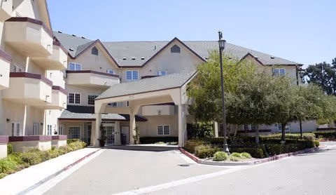 Exterior view of Merrill Gardens at Santa Maria showing the entrance and landscaping.
