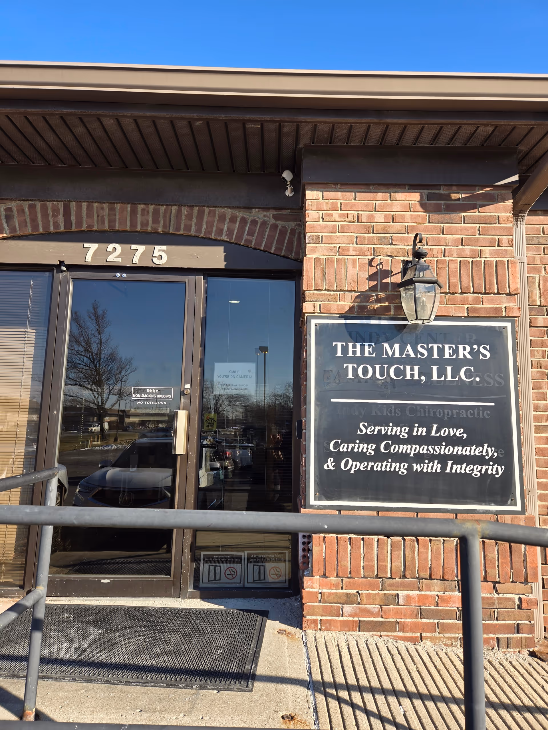 Brick building with glass doors and sign for The Master's Touch, LLC.