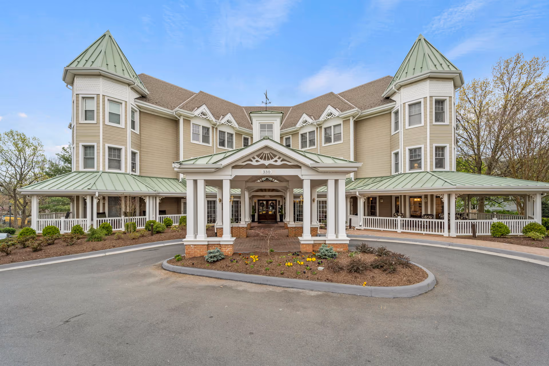 Sunrise of Falls Church senior living facility exterior with a central porte-cochere entrance.