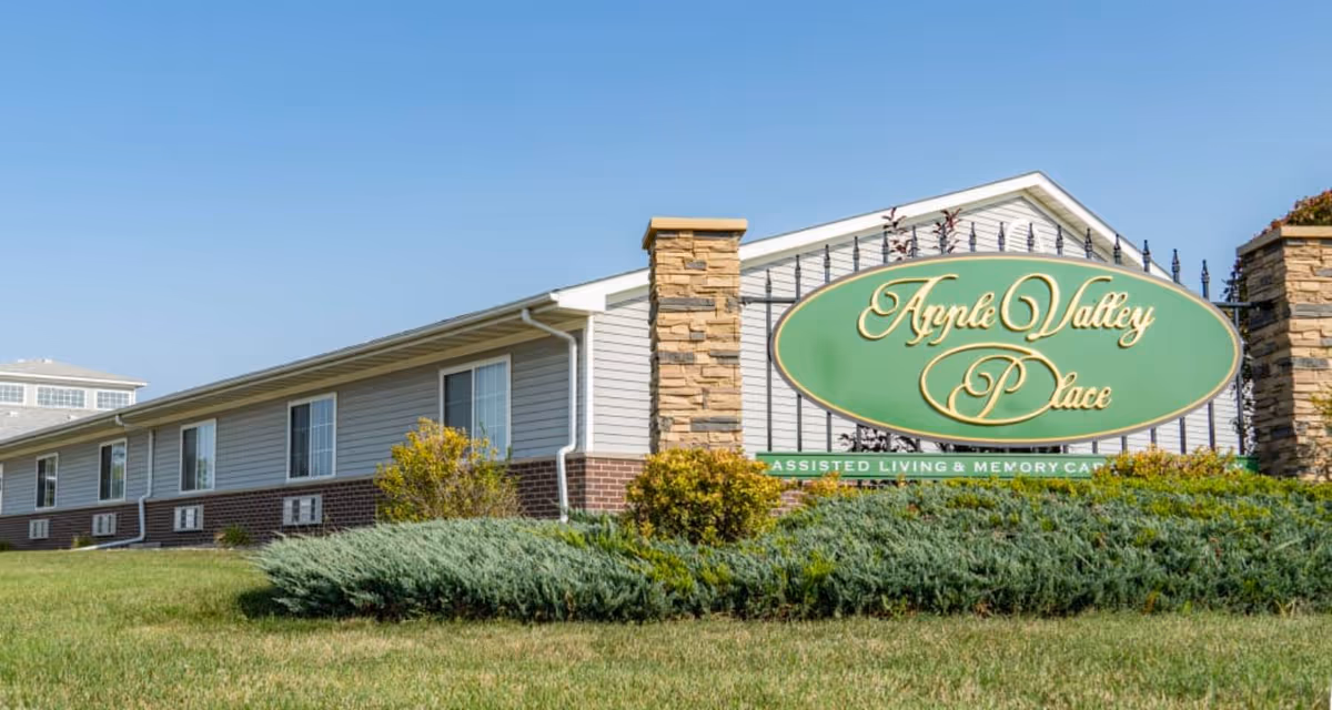 Exterior view of Apple Valley Place front sign with landscaping.