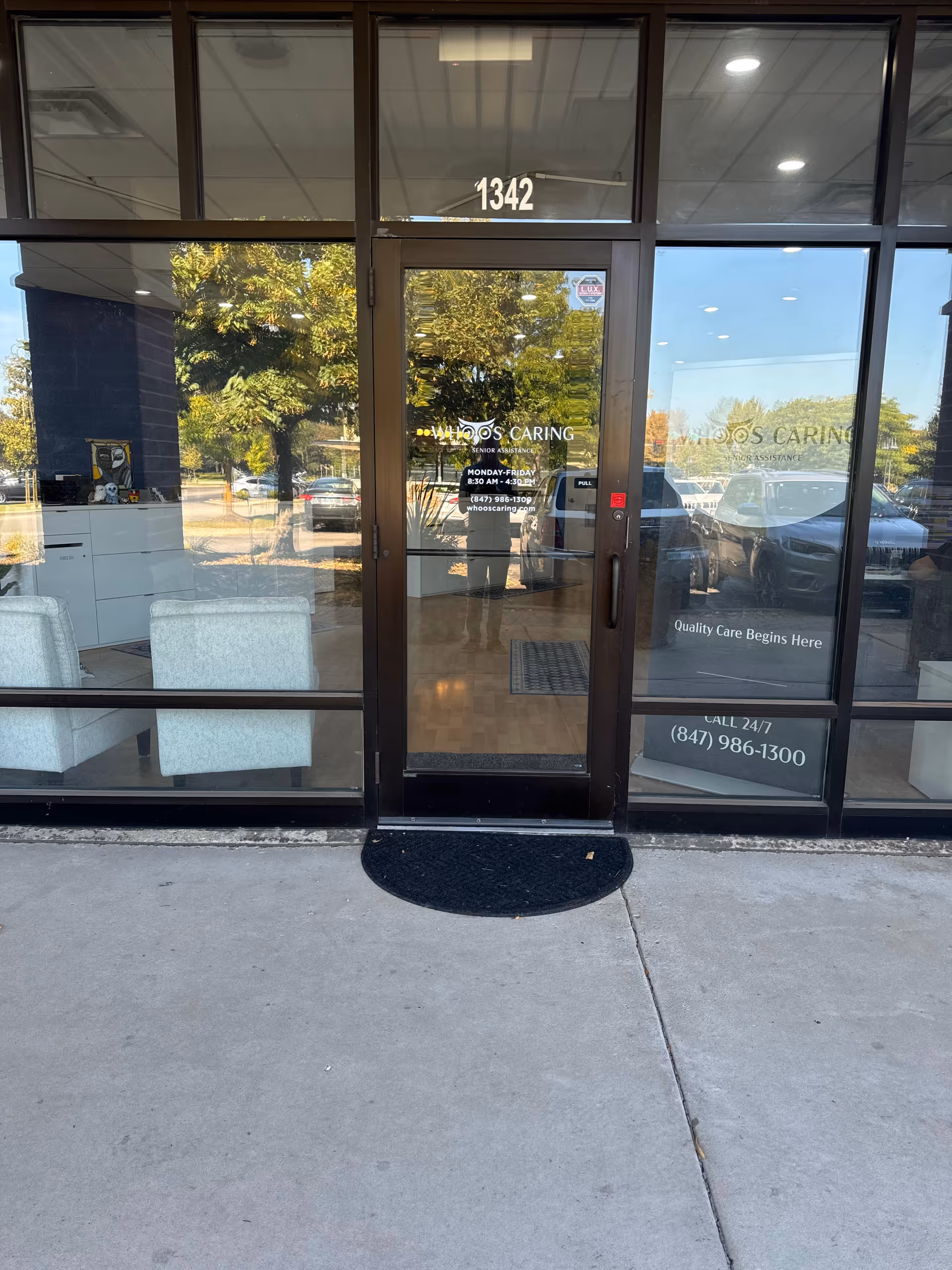 Glass storefront entrance with double doors labeled 1342, showing a lobby area inside.