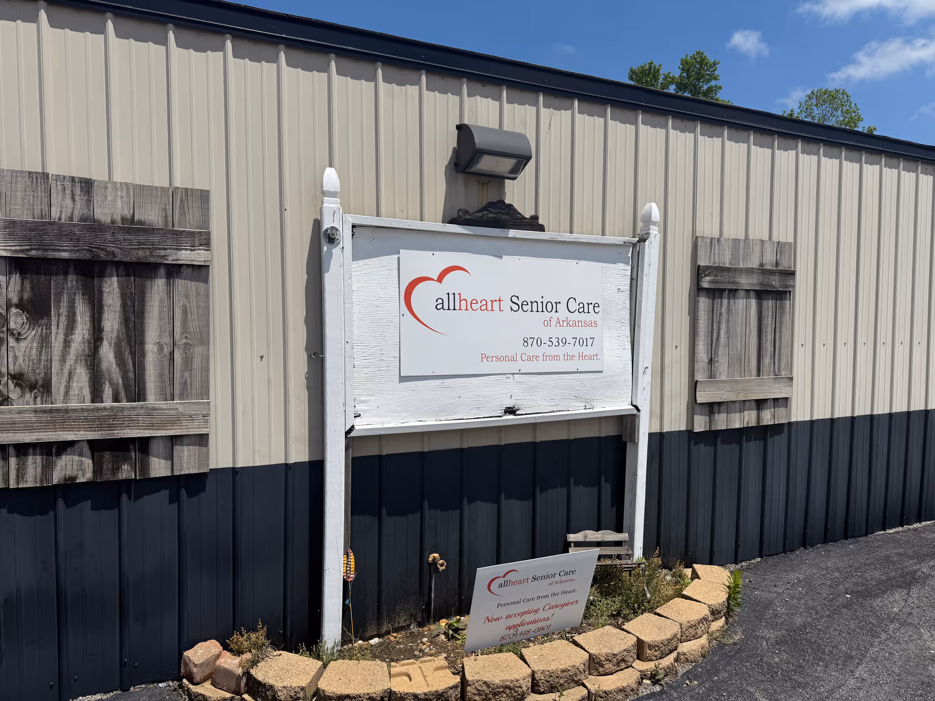 Exterior view of Allheart Senior Care facility with sign on building.