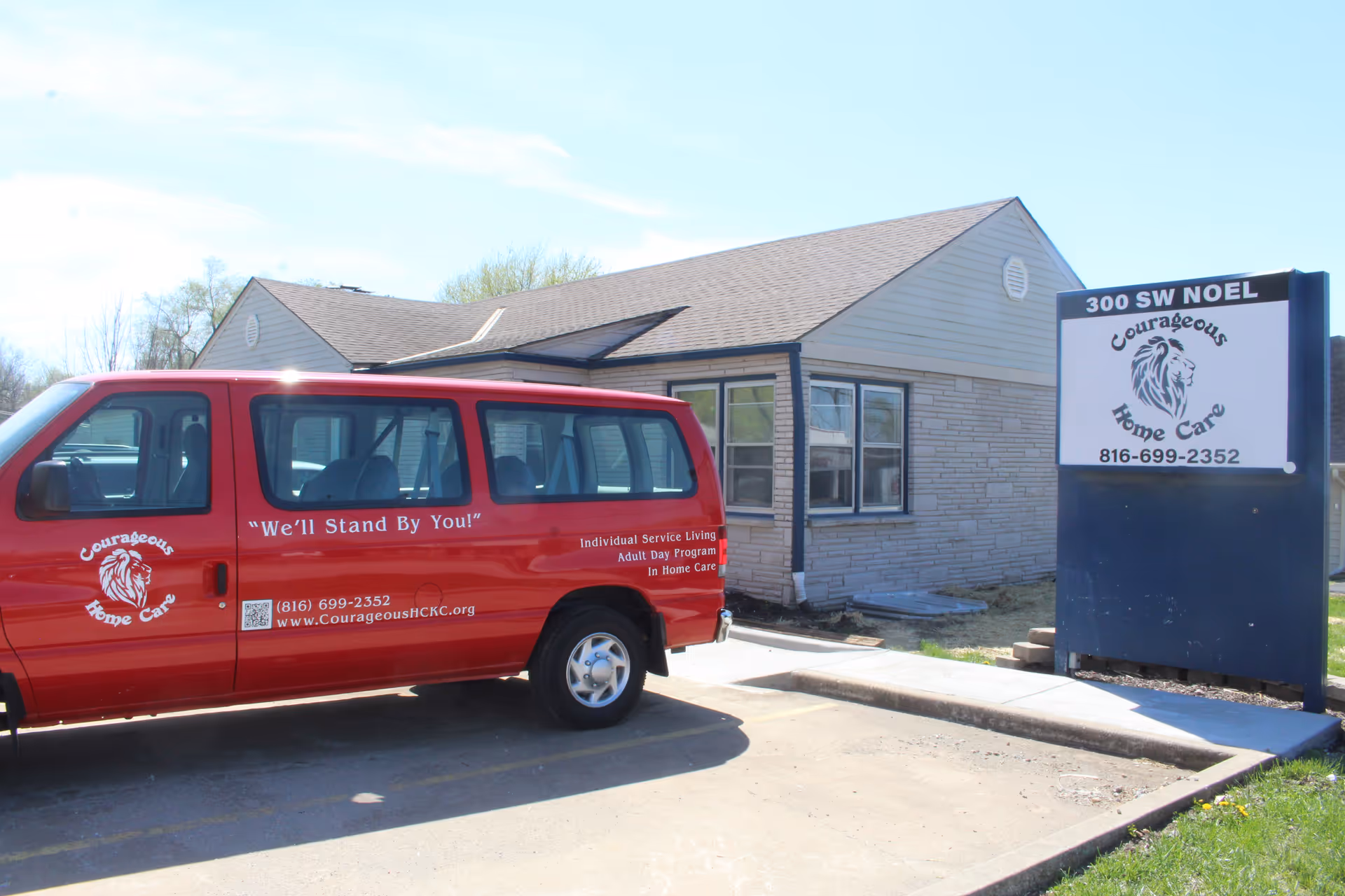 Red Courageous Home Care van parked in front of a brick facility.