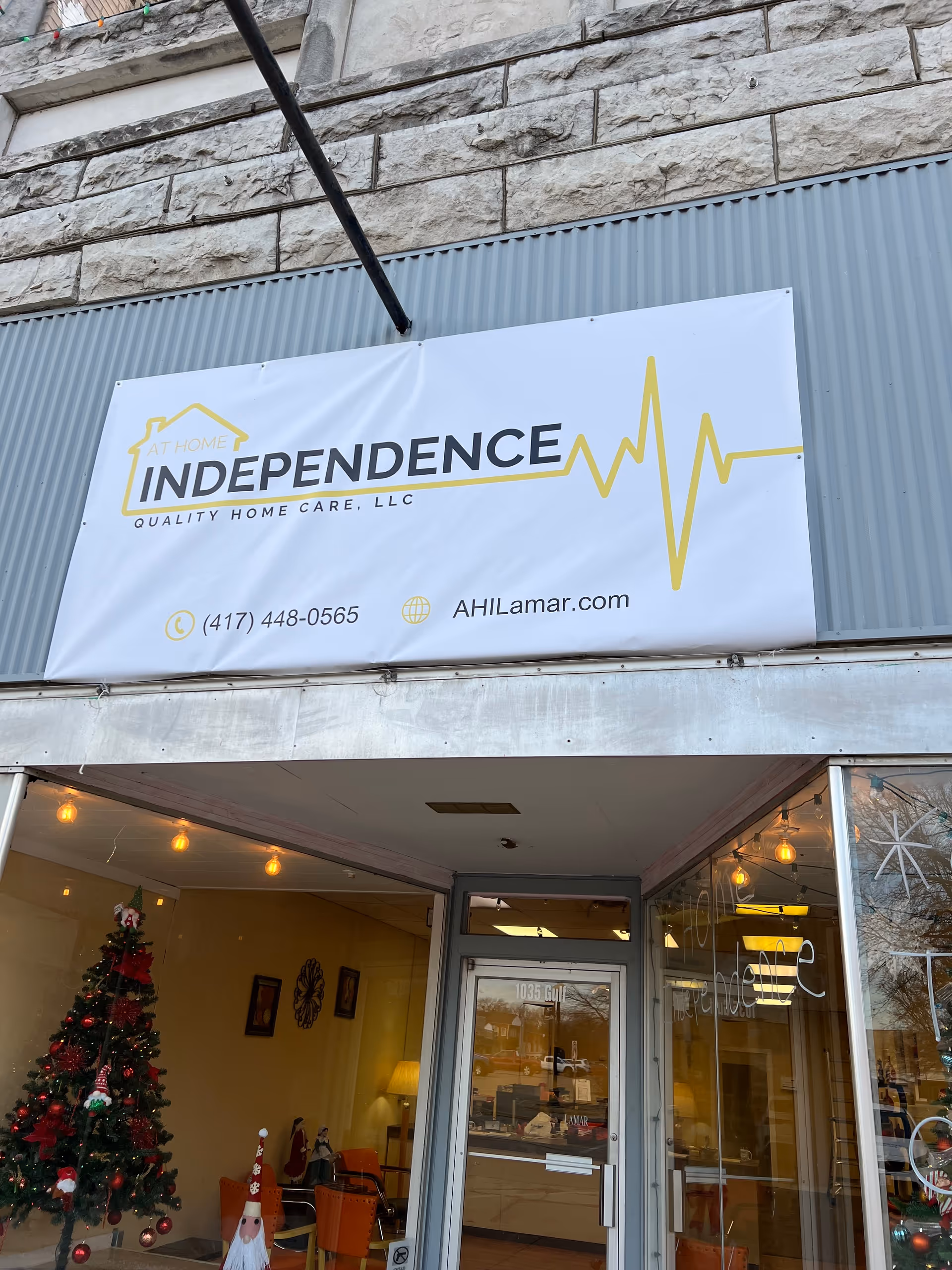 Exterior storefront with At Home Independence sign and visible lobby interior through glass doors.
