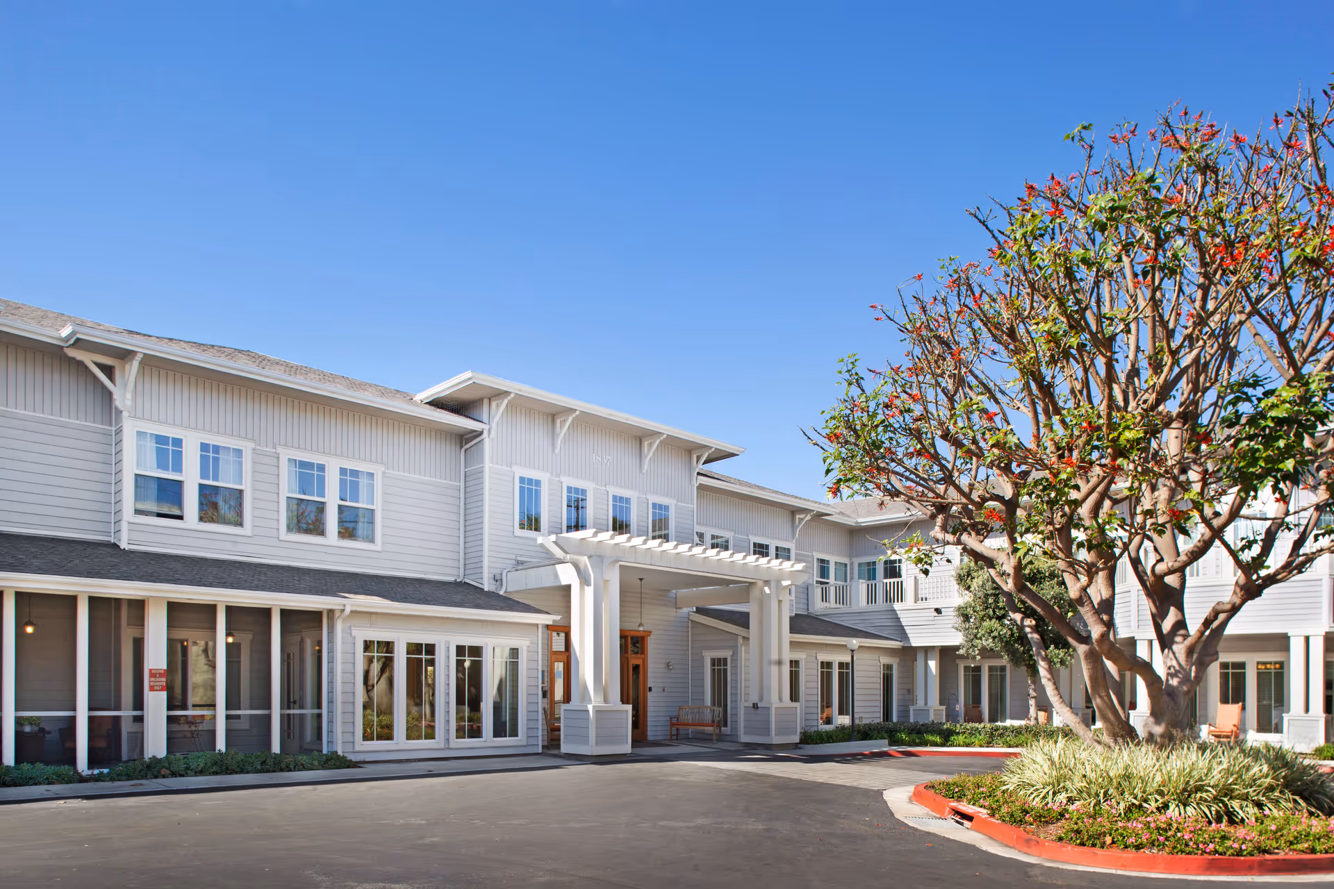 Sunrise of Hermosa Beach exterior showing the front entrance and surrounding landscaping.
