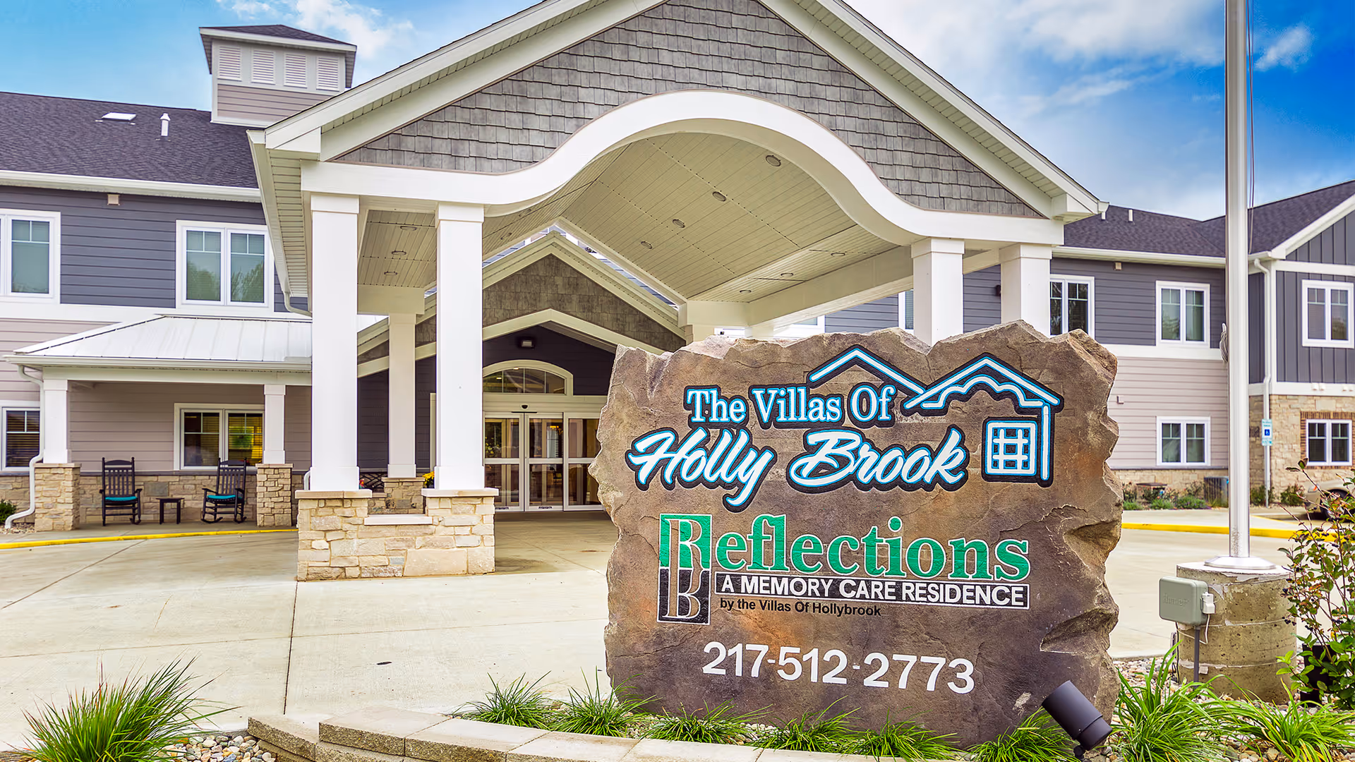 Exterior view of The Villas Of Holly Brook Charleston entrance with large rock sign.
