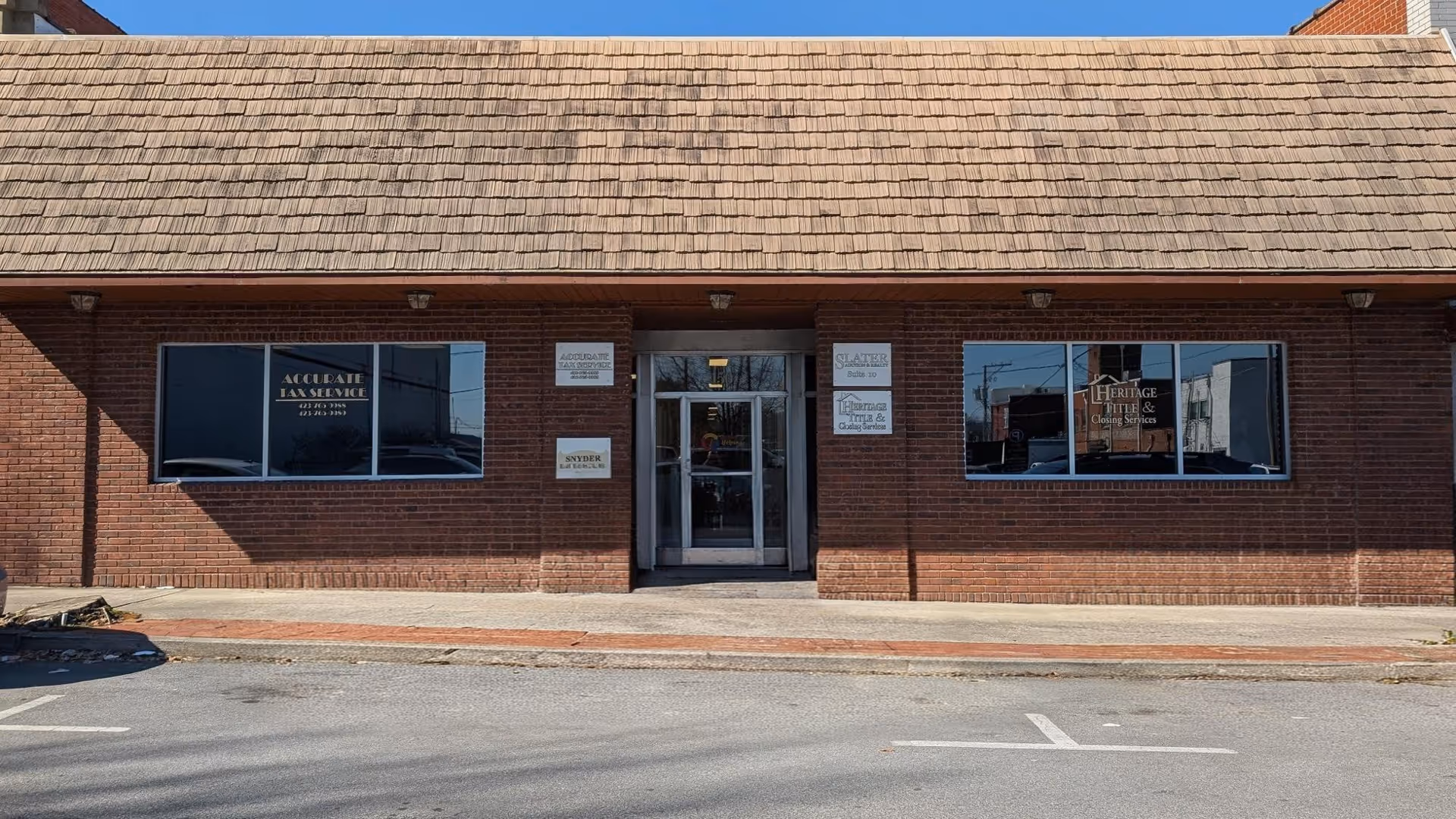 Brick building storefront with signage reading Seniors Helping Seniors Tri-Cities.