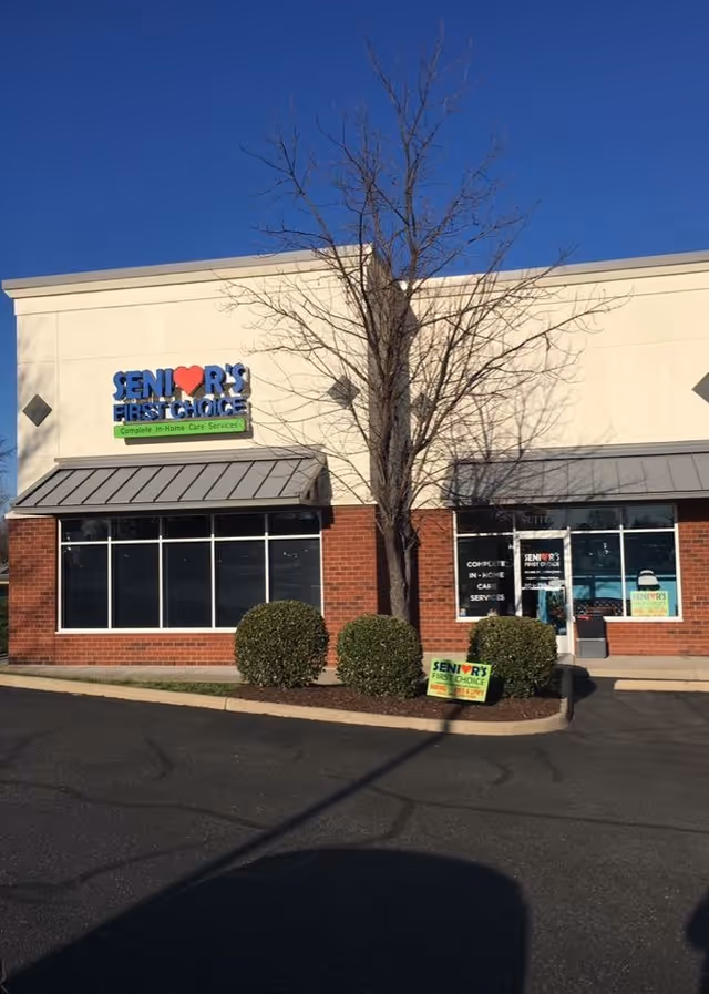 Exterior view of Senior's First Choice building with brick lower facade and sign.