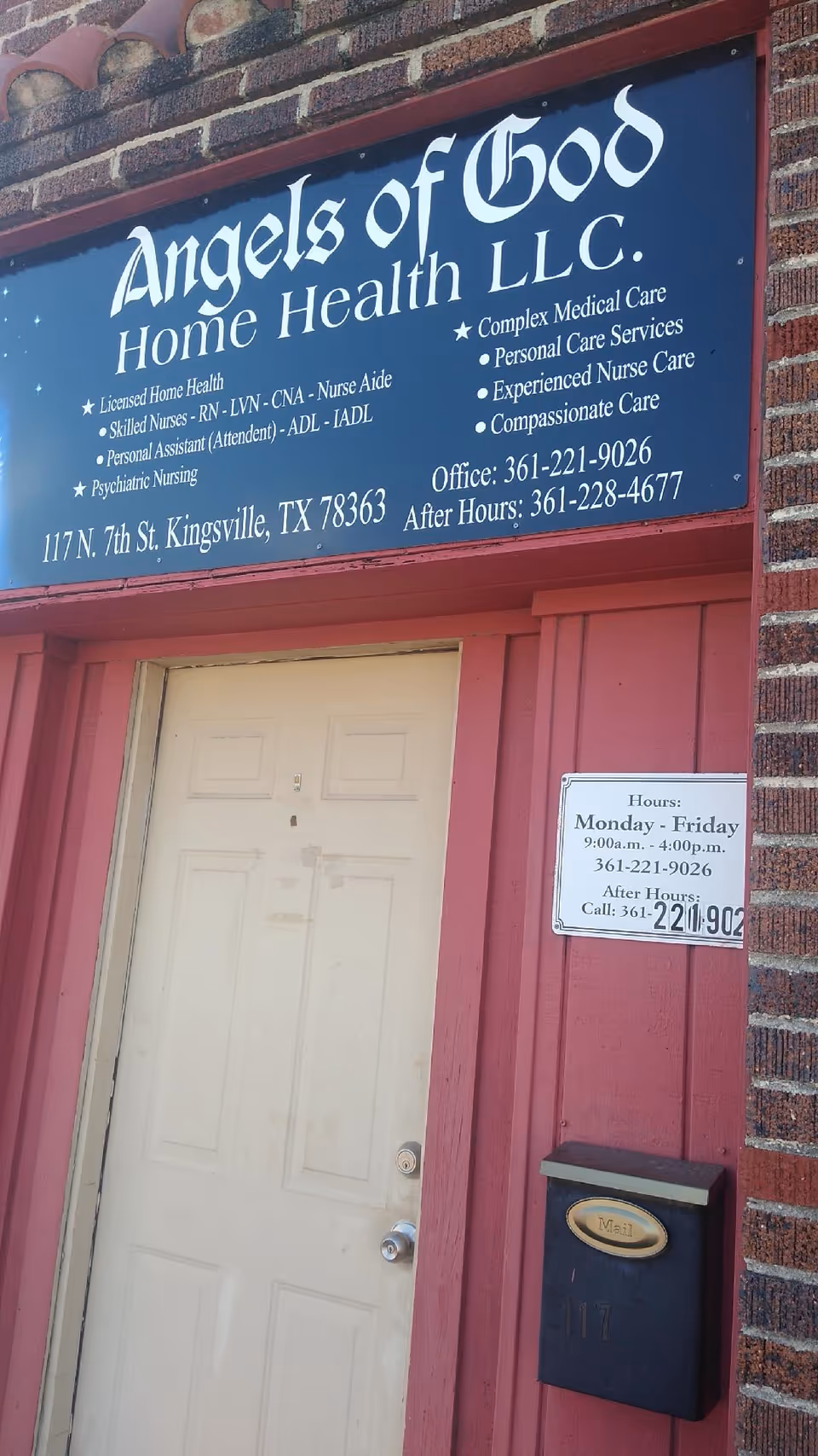 Exterior view of Angels of God Home Health LLC sign above a pink doorway.