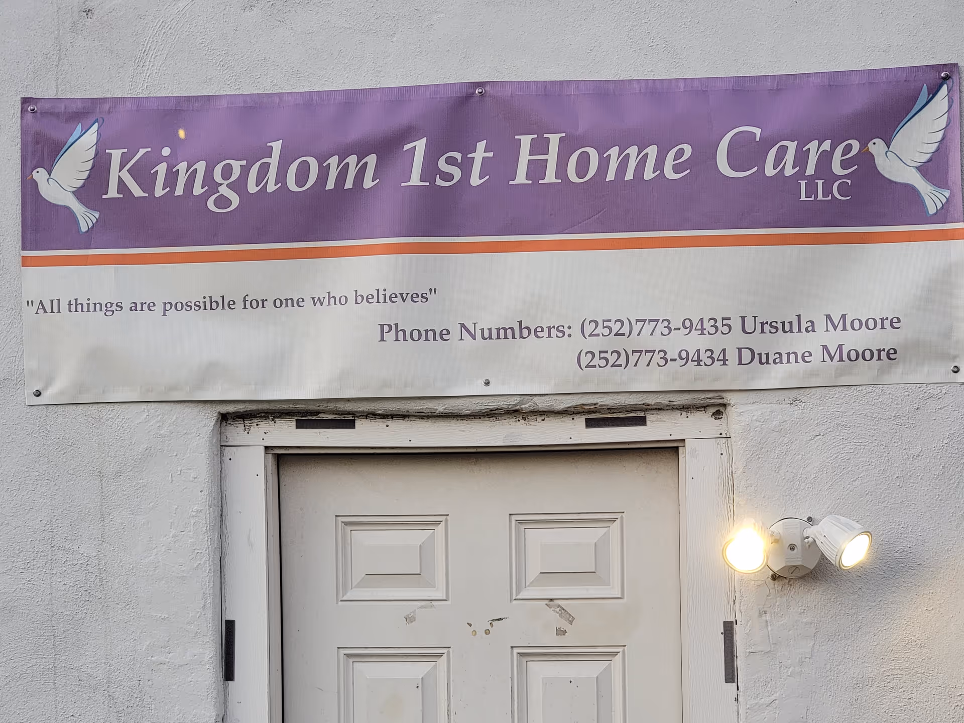 Purple banner reading Kingdom 1st Home Care LLC above a white door.