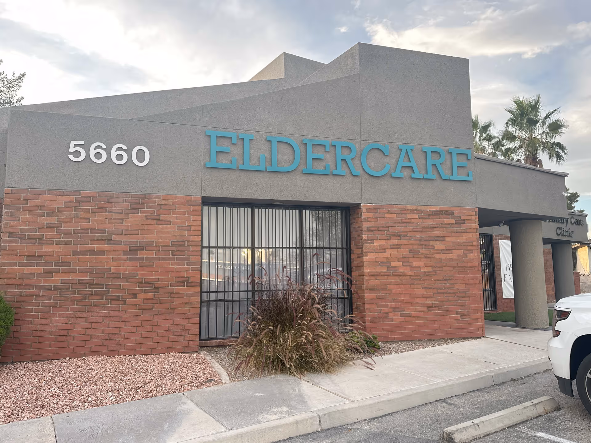 Exterior view of ElderCare building with turquoise ELDERCARE sign and brick facade at 5660.