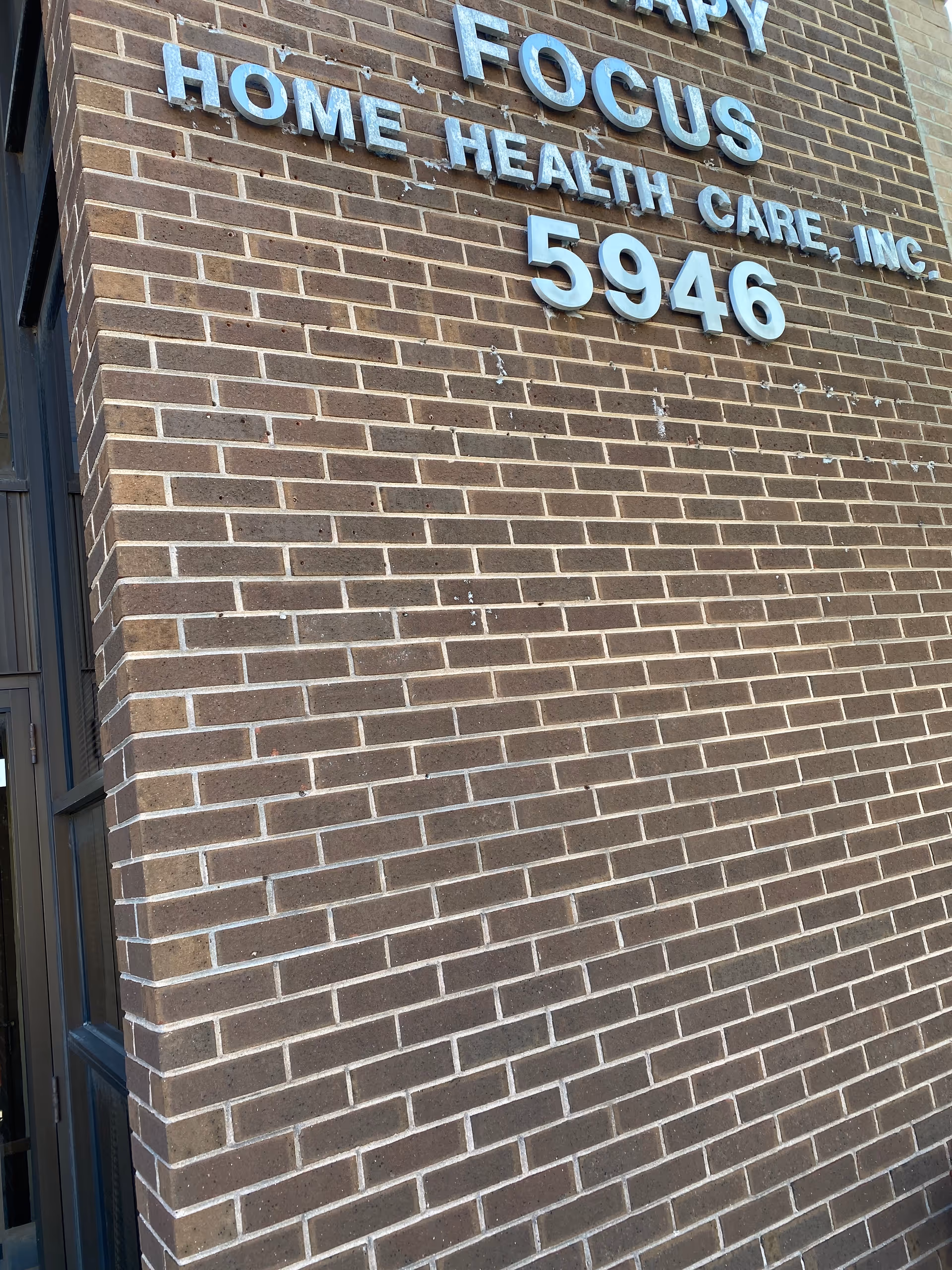 Brick exterior wall with Focus Home Health Care, Inc sign and numbers