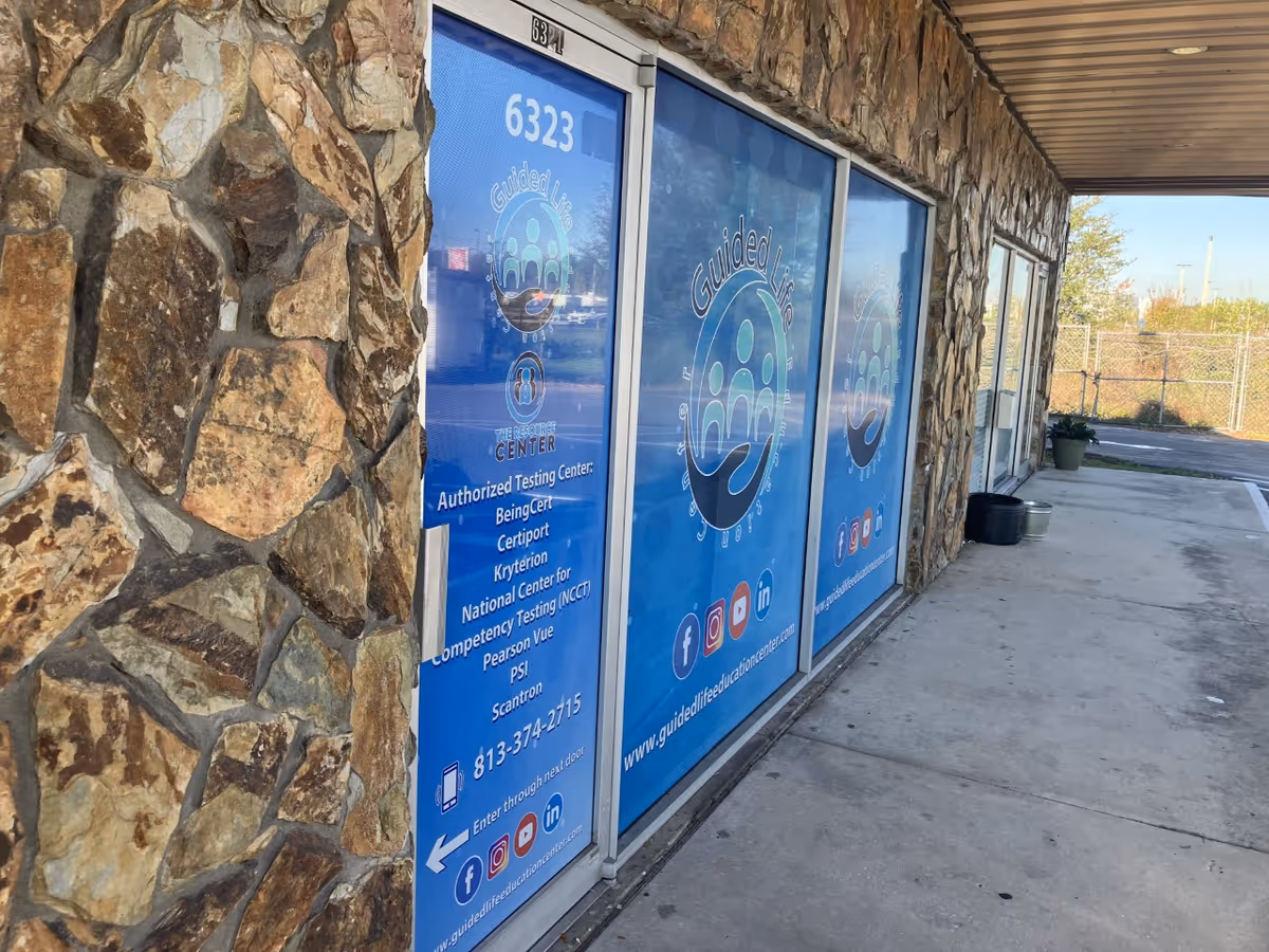Stone exterior with blue glass doors displaying Guided Life Care logos.