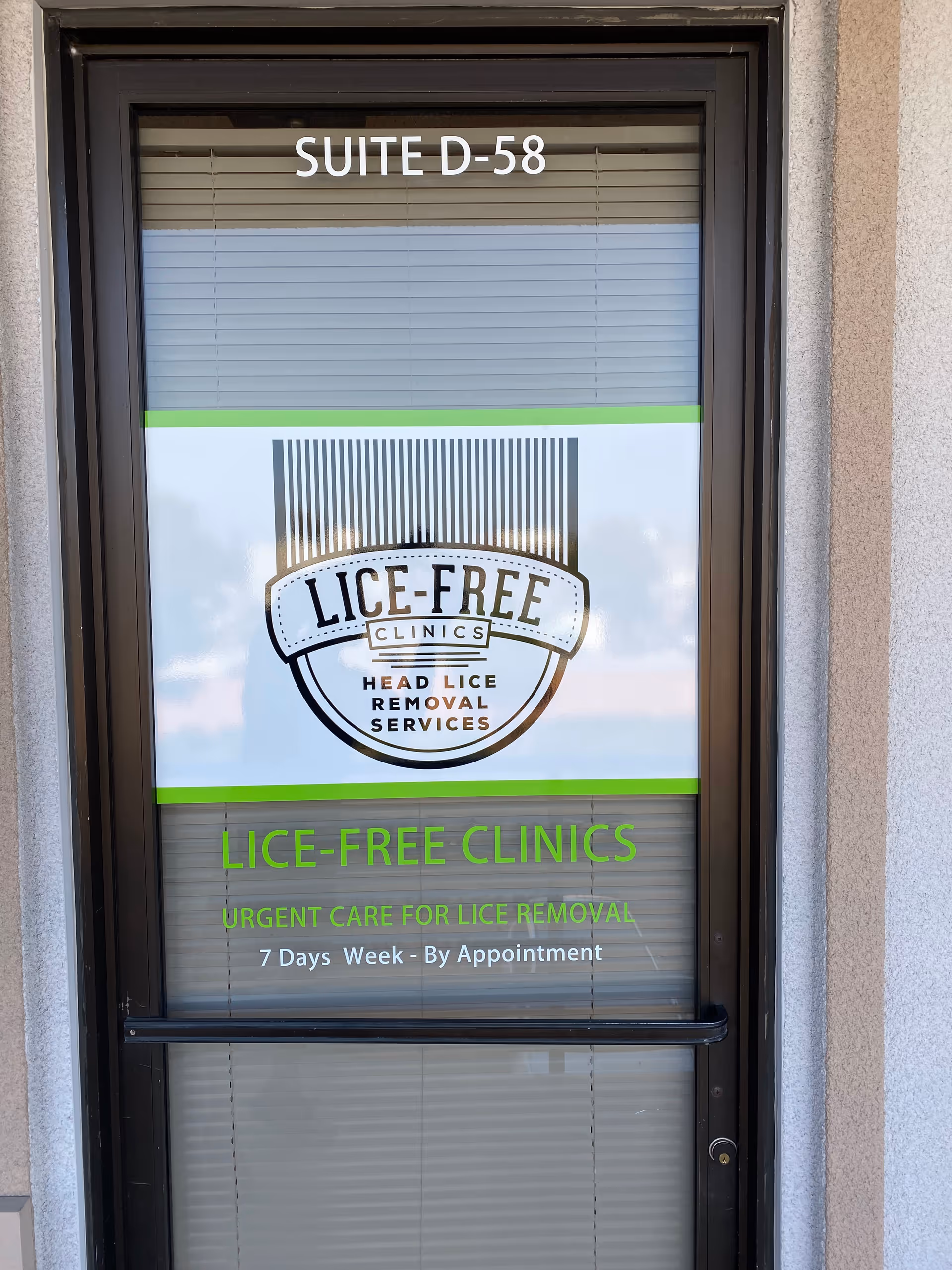 Front door of Lice-Free Clinics storefront displaying large logo and green signage.