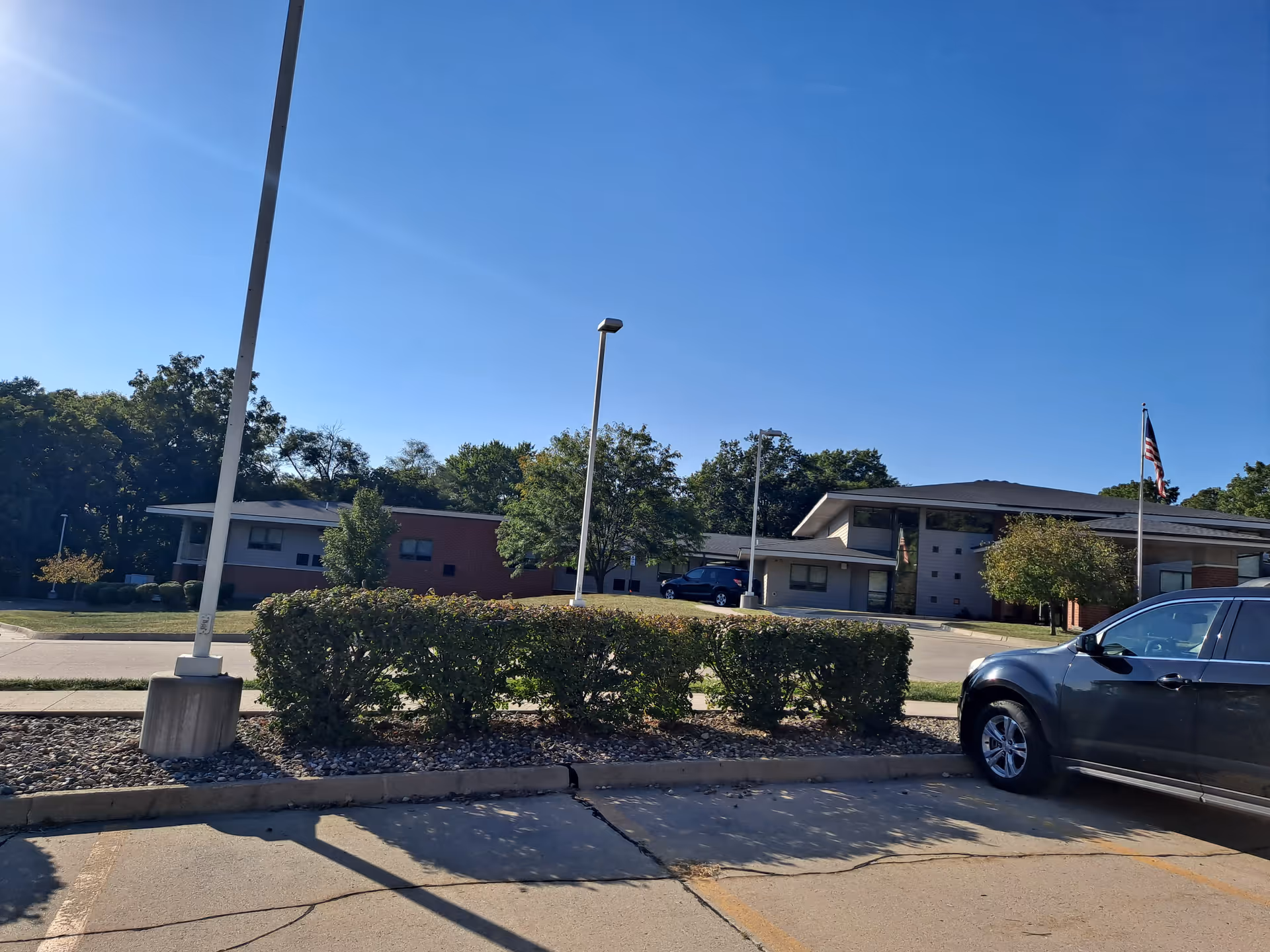 Exterior view of EveryStep senior living facility with parking lot and blue sky.