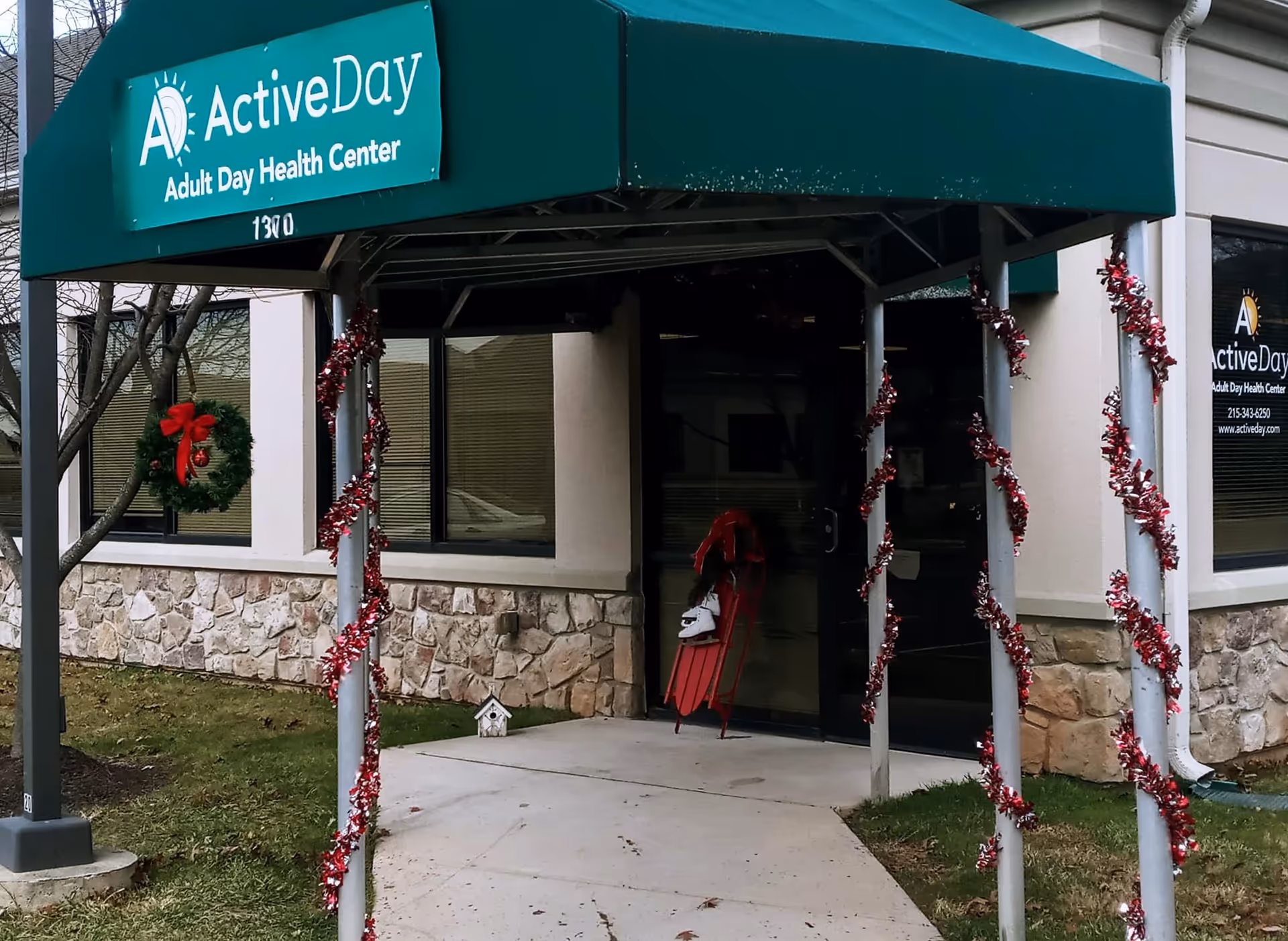 Exterior view of Active Day Adult Day Health Center entrance with festive decorations.