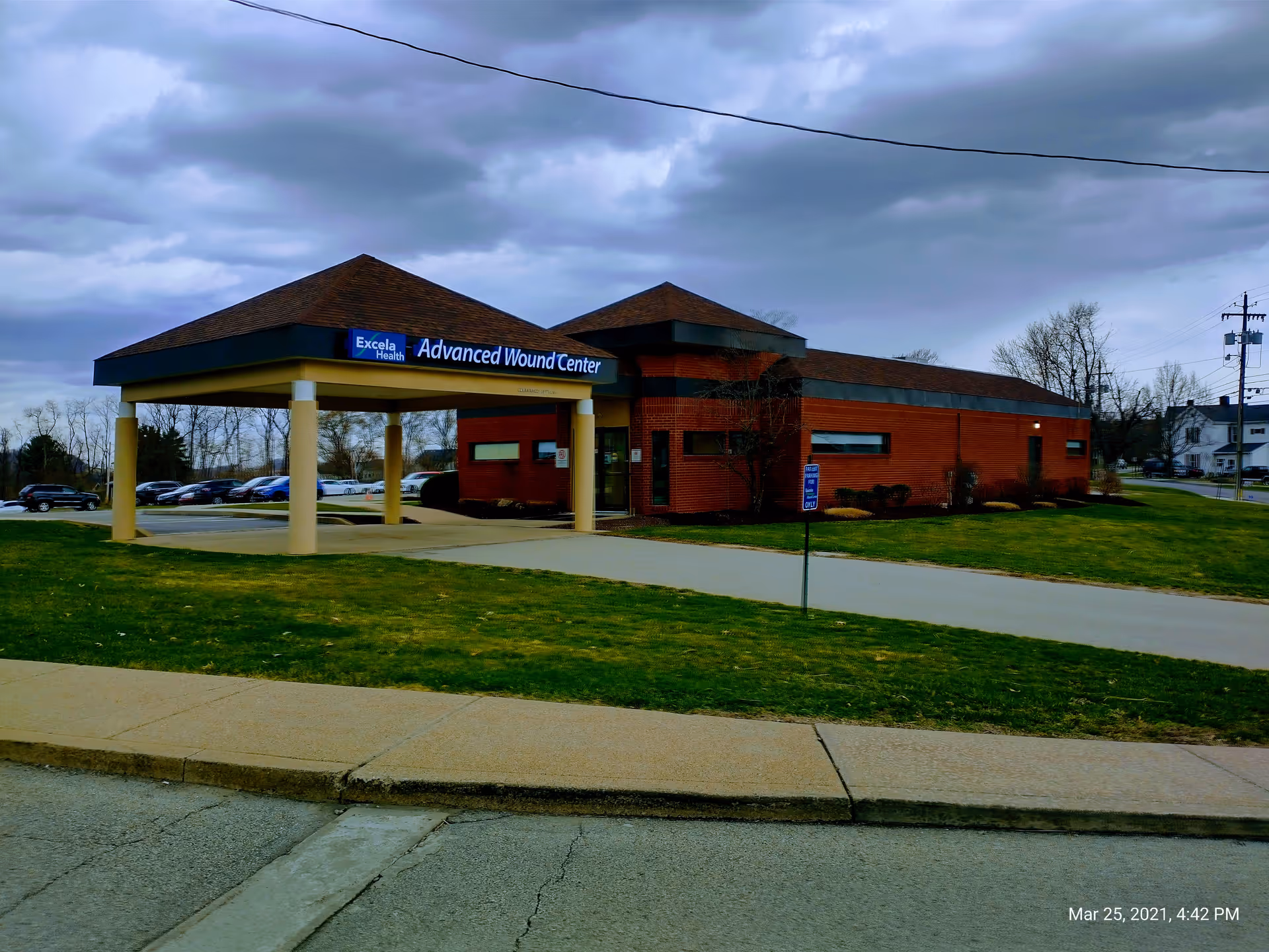 Exterior view of a brick medical center with a covered entrance and Advanced Wound Center sign.