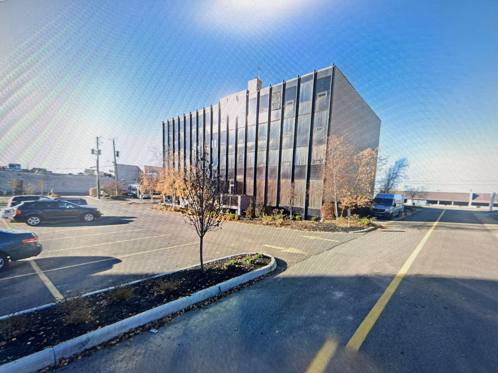 Hope Home Health Care LLC building shown in a parking lot with a modern glass facade.