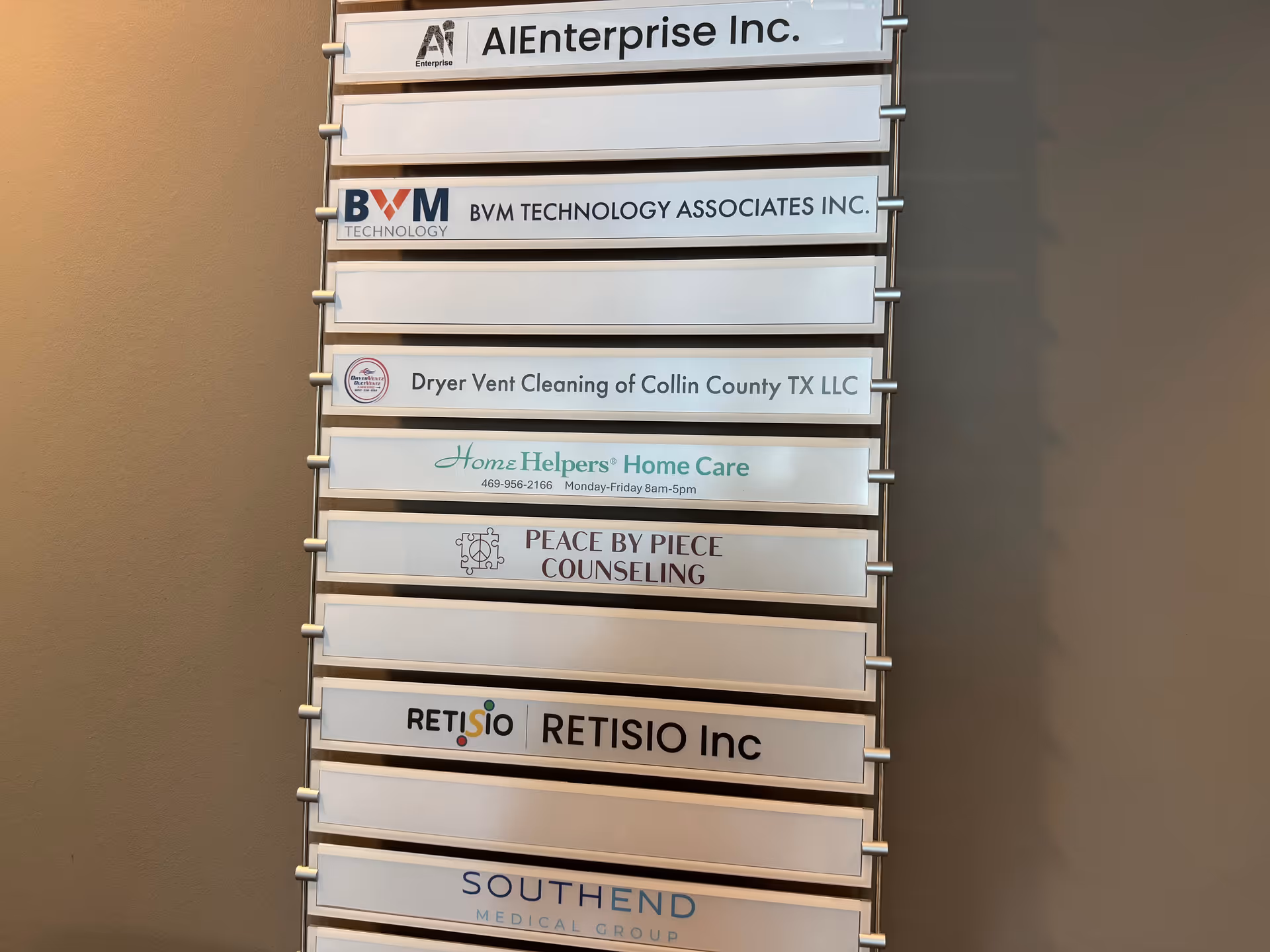 Vertical directory sign listing tenant names, including Home Helpers Home Care