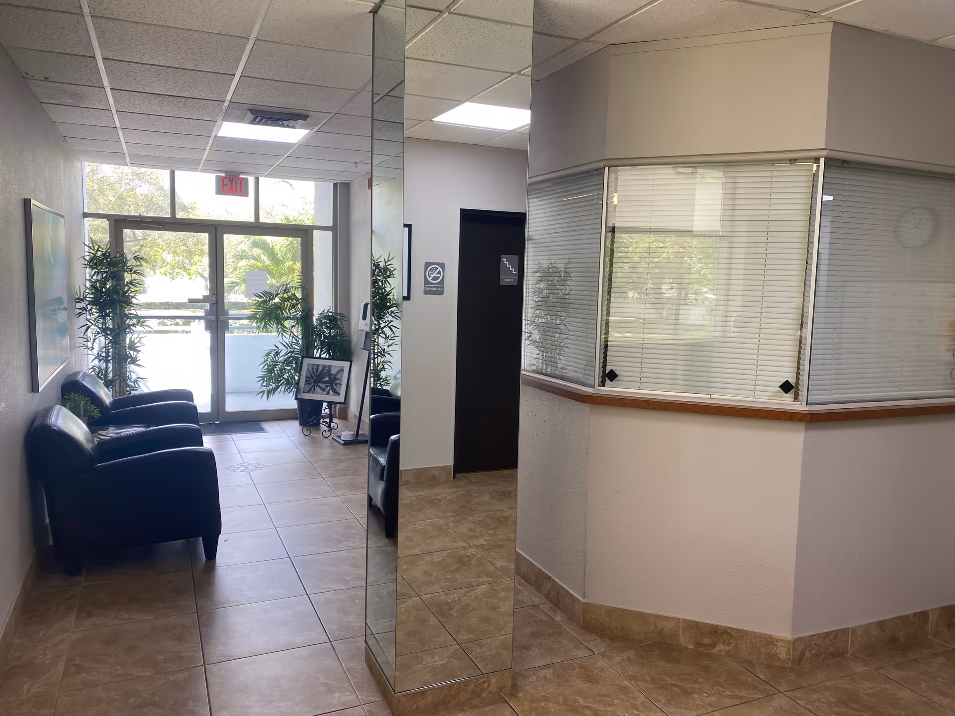 Interior lobby of Caring Home Health Center with seating and a glass entrance.
