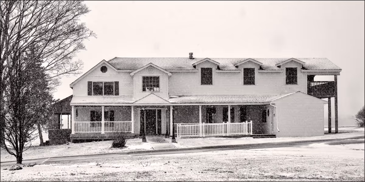 Two-story senior living facility with a wide front porch.