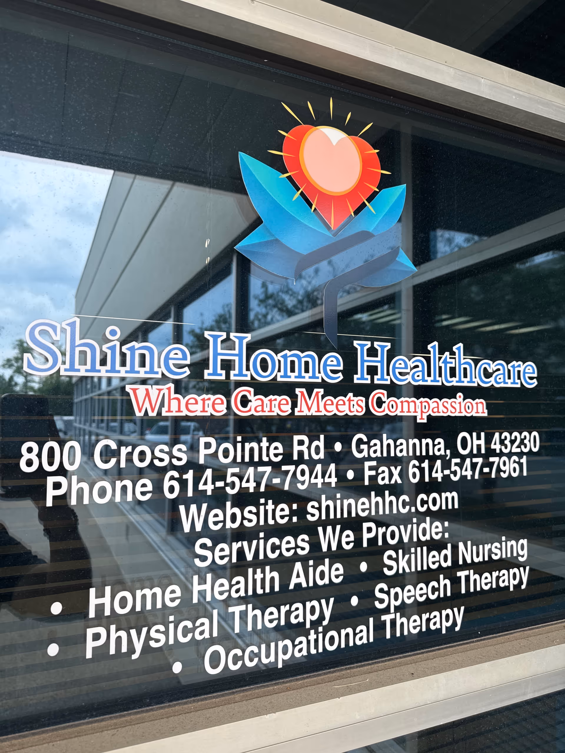 Front window of Shine Home Healthcare with logo and address, phone, and services listed.