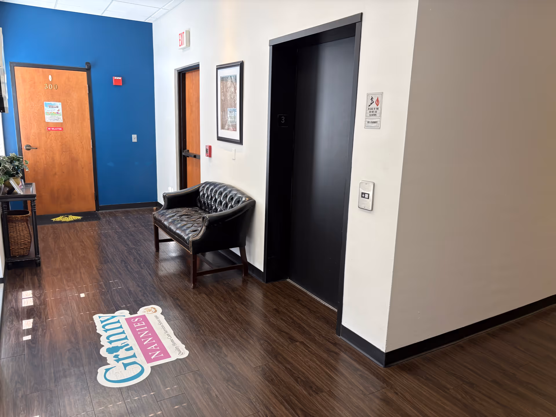 Interior hallway of Granny NANNIES Senior Home Care Orlando with blue accent wall and seating.