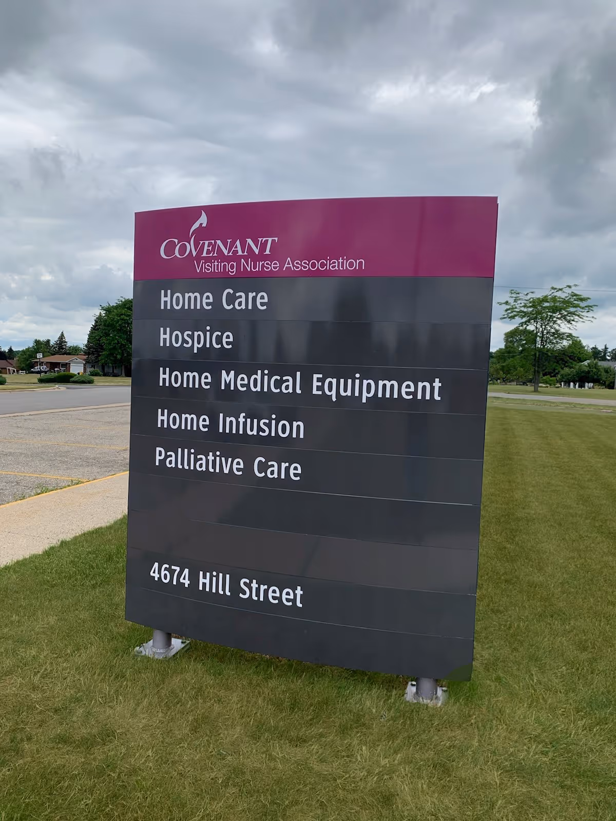 Outdoor sign for Covenant Visiting Nurse Association listing services and address.