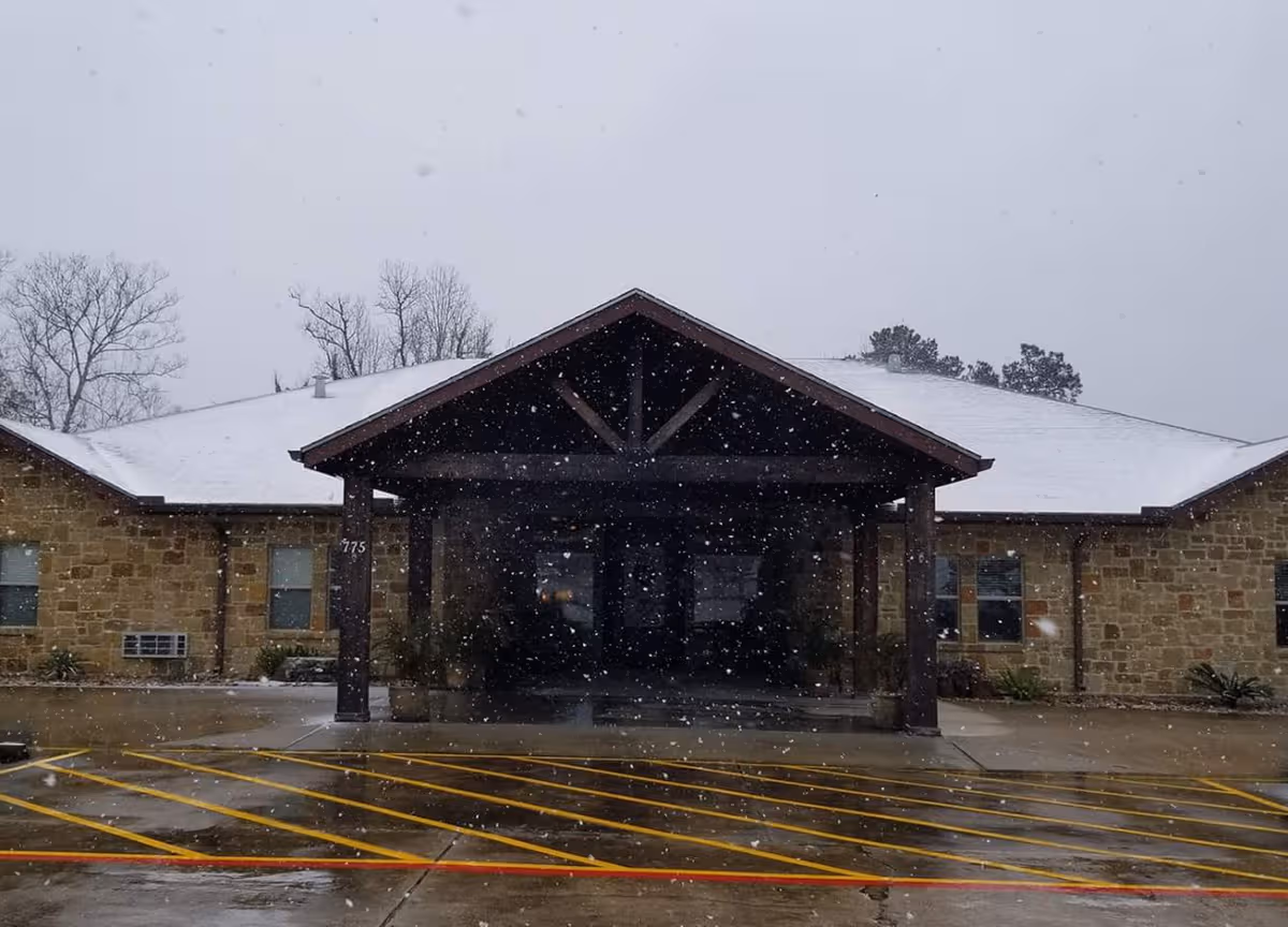Snow falls on the front entrance of Spanish Trail Assisted Living of Silsbee.